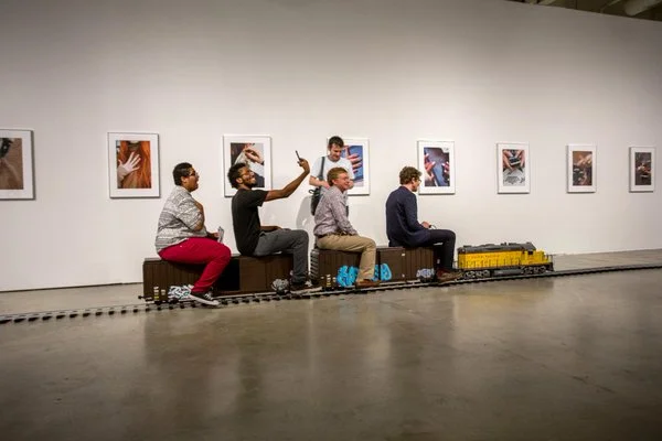 Our 1" GP-20 with High Cube boxcar train consist was built for an interactive visual art install for Josephine Pryde and was nominated in the UK for the Turner prize last year. Our train was run by hundreds of people unfamiliar with the hobby at various gallerys across the U.S. Two to three people can ride comfortably on the Hi-Cube boxcars shown above. Looks like the engineer is having fun!