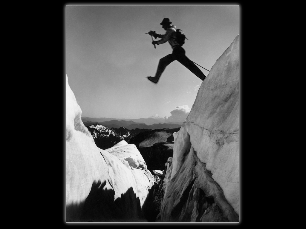 Photographer Ira Spring set up his large view camera on Mt. Rainier and had Jim jump this crevasse “twice for black and white and three times for color." Mt. St. Helens – pre eruption – is in the background. Ira Spring Photo