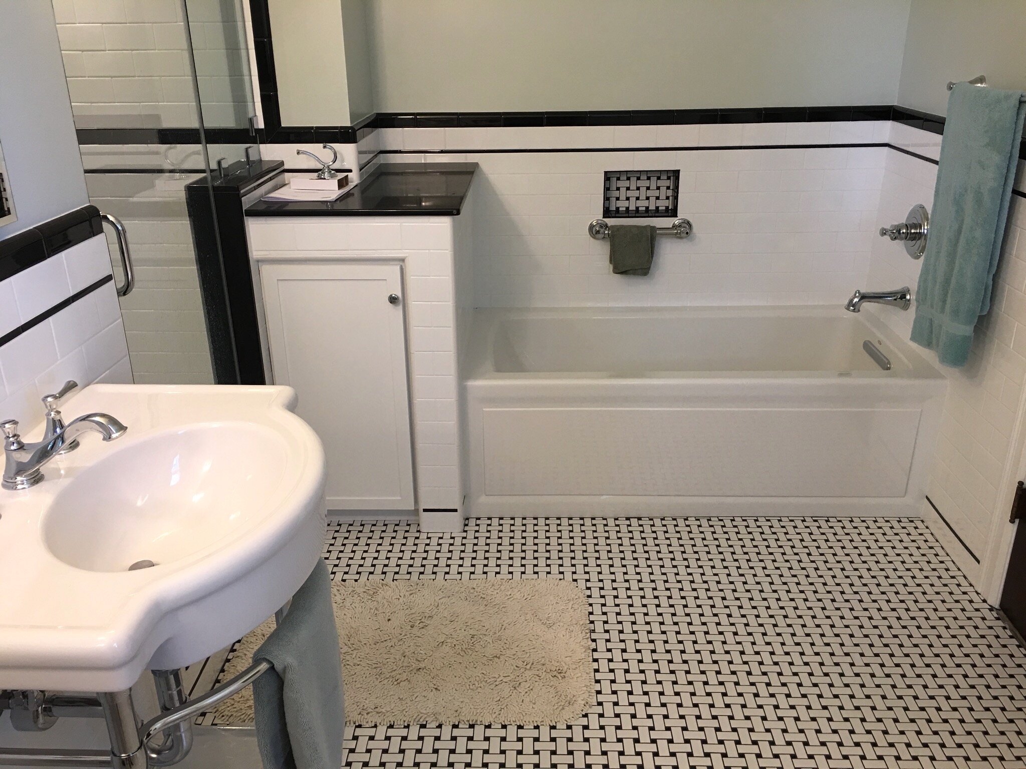 Full Bathroom Remodel: New Plumbing, Tub, Wall and Floor Tiles, Vanity, Mirror, and Lighting.