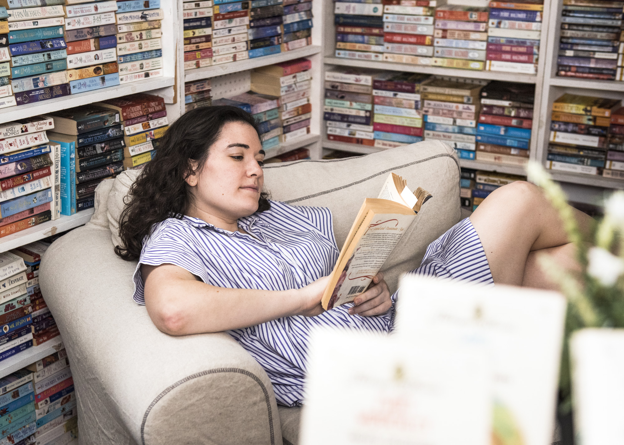 Leah lounging upstairs in their use book section.