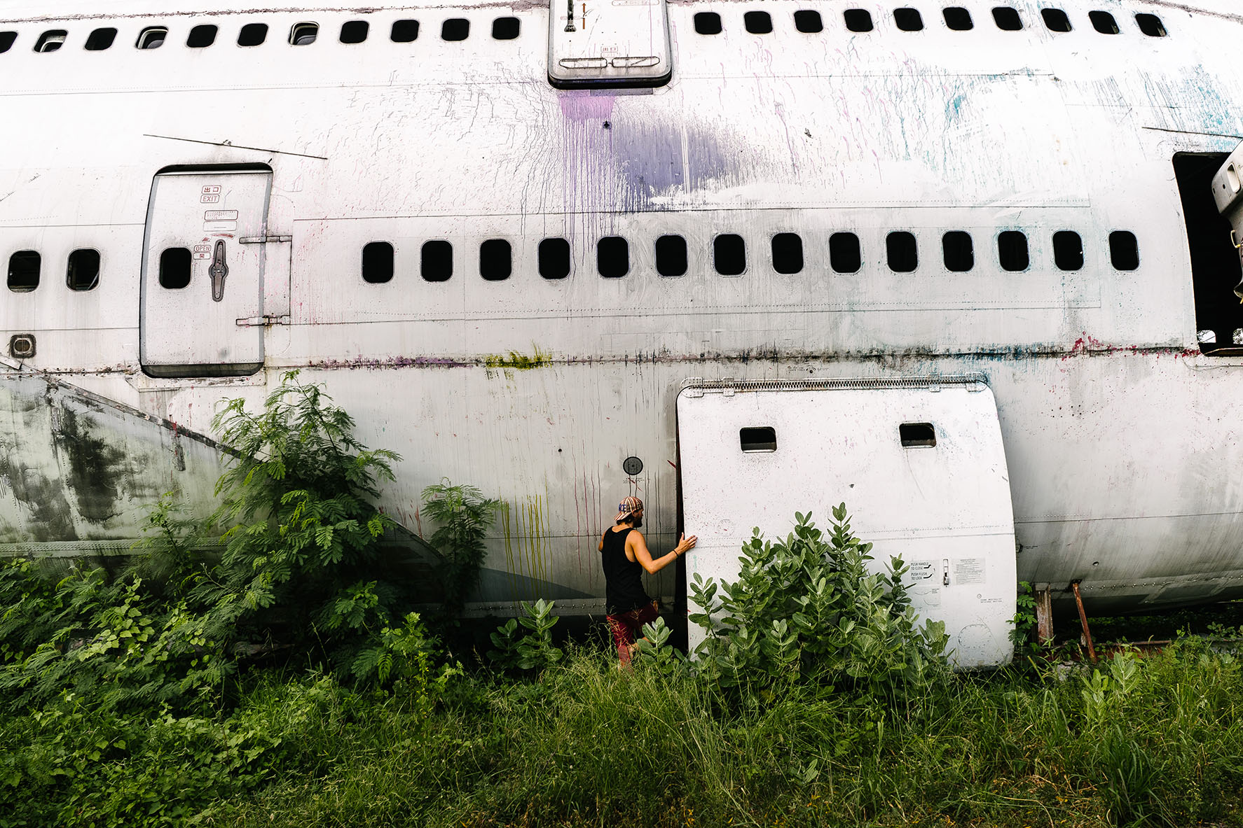 Entering the resting Boeing 747-400 fuselage, being very careful about where we put our hands and feet, as there was several sharp, jagged edges inside the old scrapped planes.
