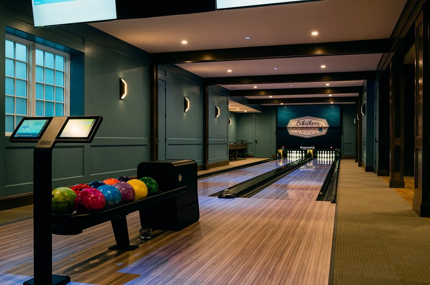 Long weekends call for fun nights on the lower level walk out at our Lakeshore Lanes Project.  From striking it big in the private bowling alley to perfecting your swing in the golf simulator, this lower-level lounge and bar was designed for non-stop