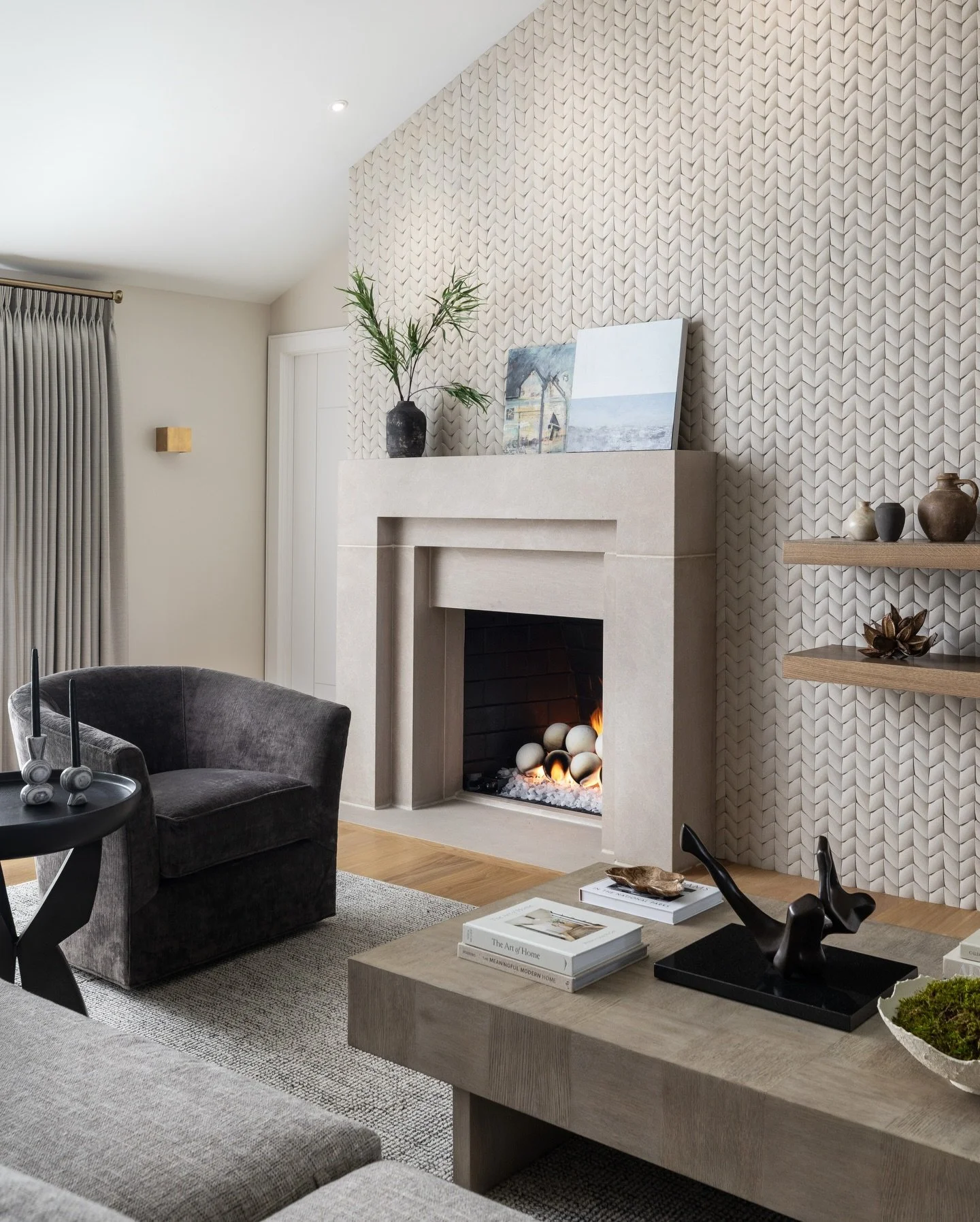 It's a cozy fire kind of day. 

This custom limestone mantel grounds the limestone tiled wall in Paragon Chevron by Island Stone and Tile. I made sure it has the proper proportions and was large enough to feel important as it layers over another stro