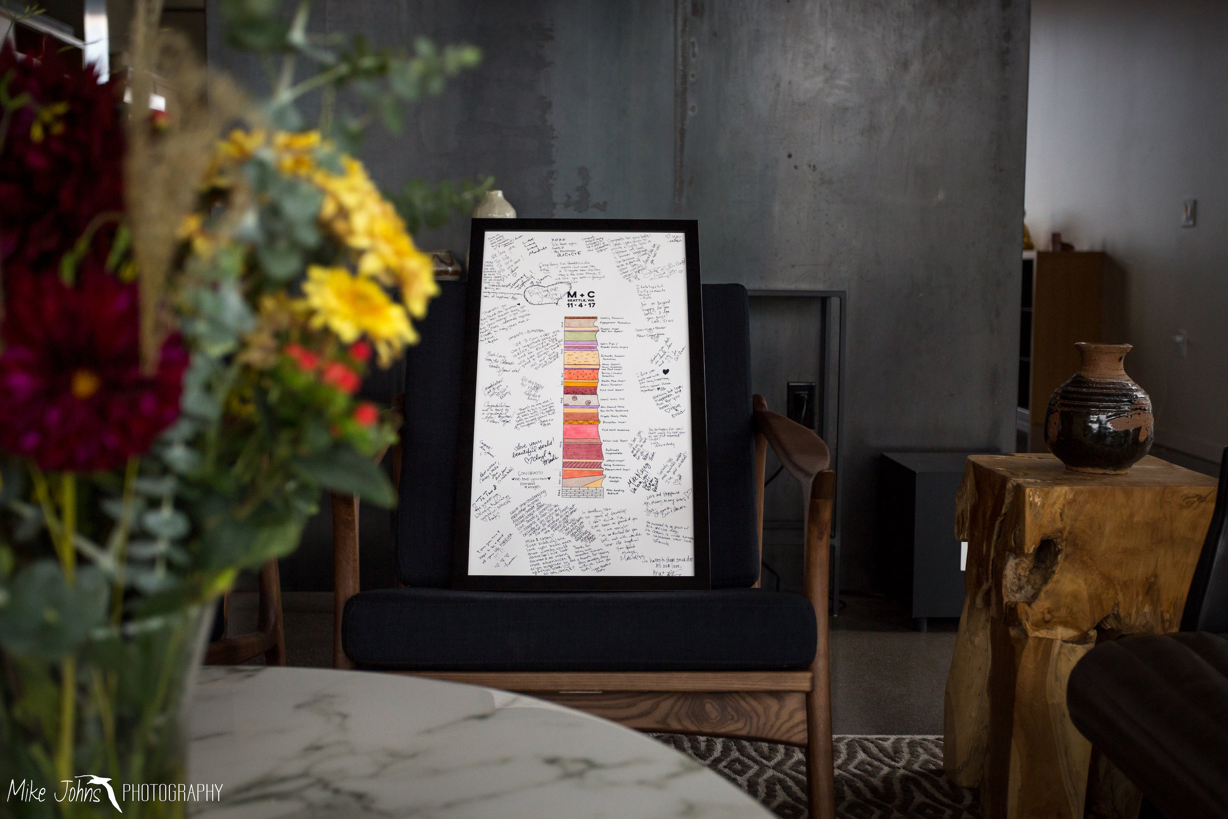  I used the idea of a geologic stratigraphic column to represent the layers of our relationship timeline. This piece of art served as the backdrop for guests to sign during the reception. The beautiful simple floral arrangements, like the one in the 