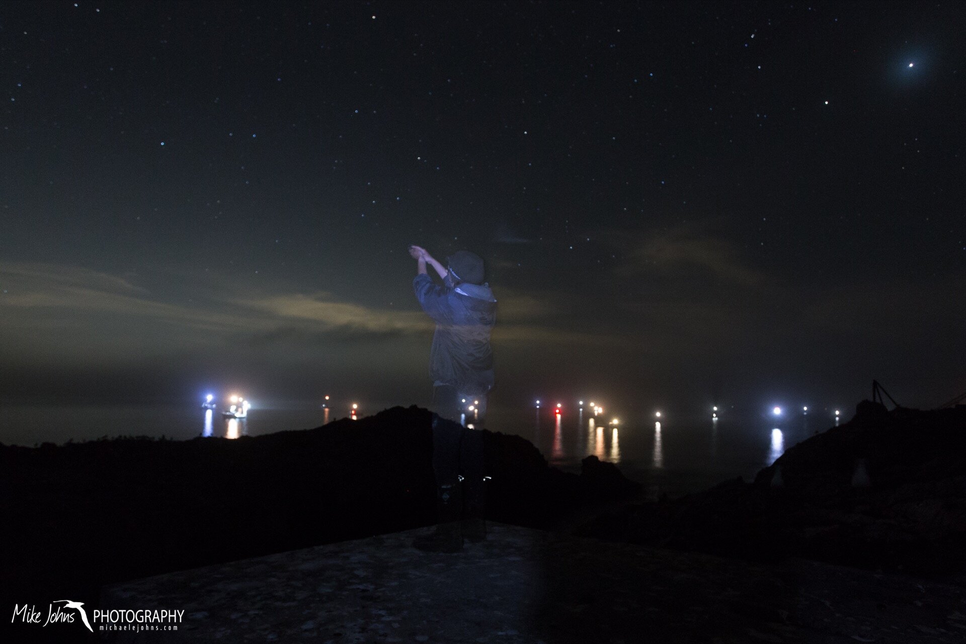  Releasing a banded storm-petrel with the lights of a sleeping fishing fleet taking shelter for the night.  