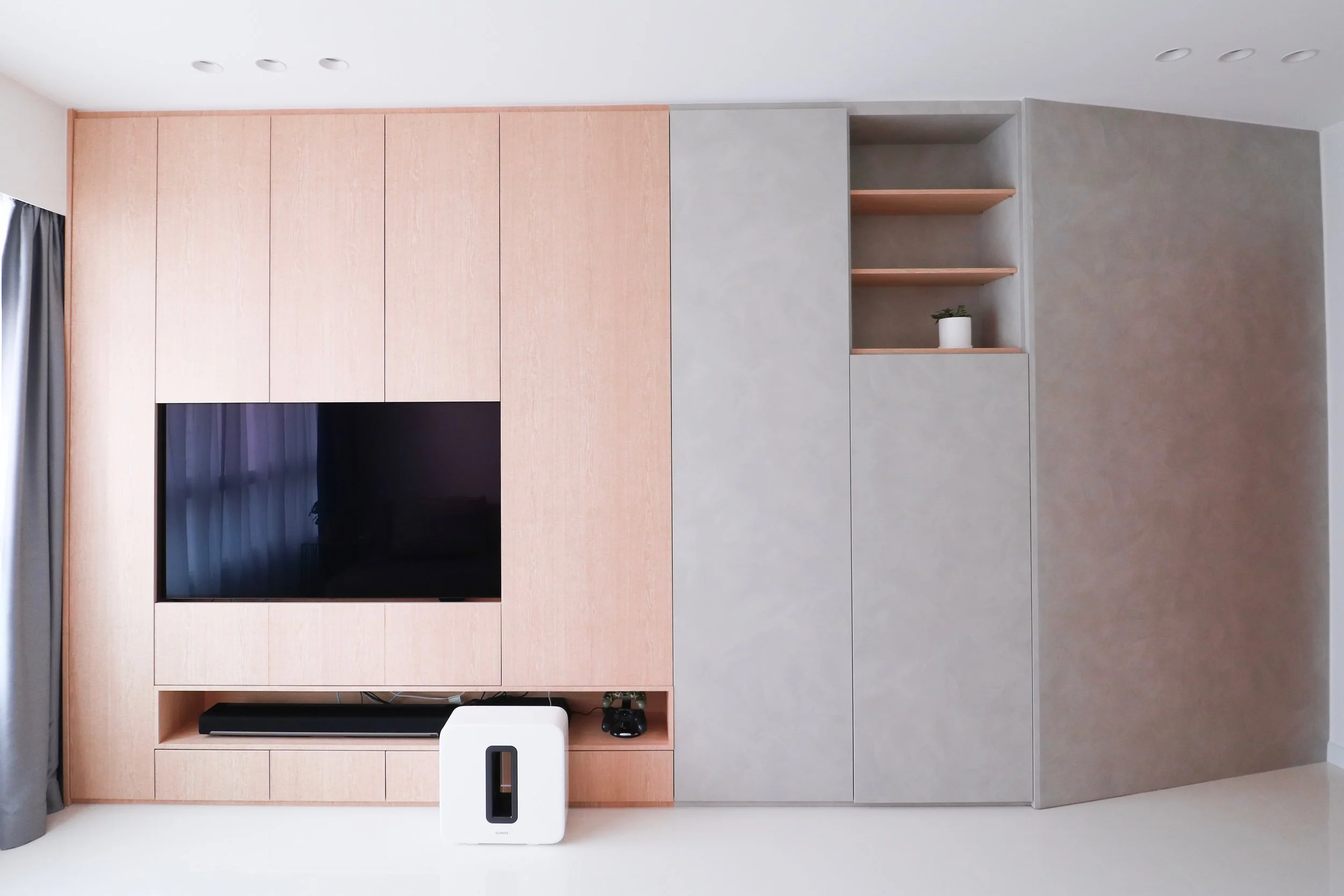 Wide angle view of the living area; Full width built in cabinet + feature wall