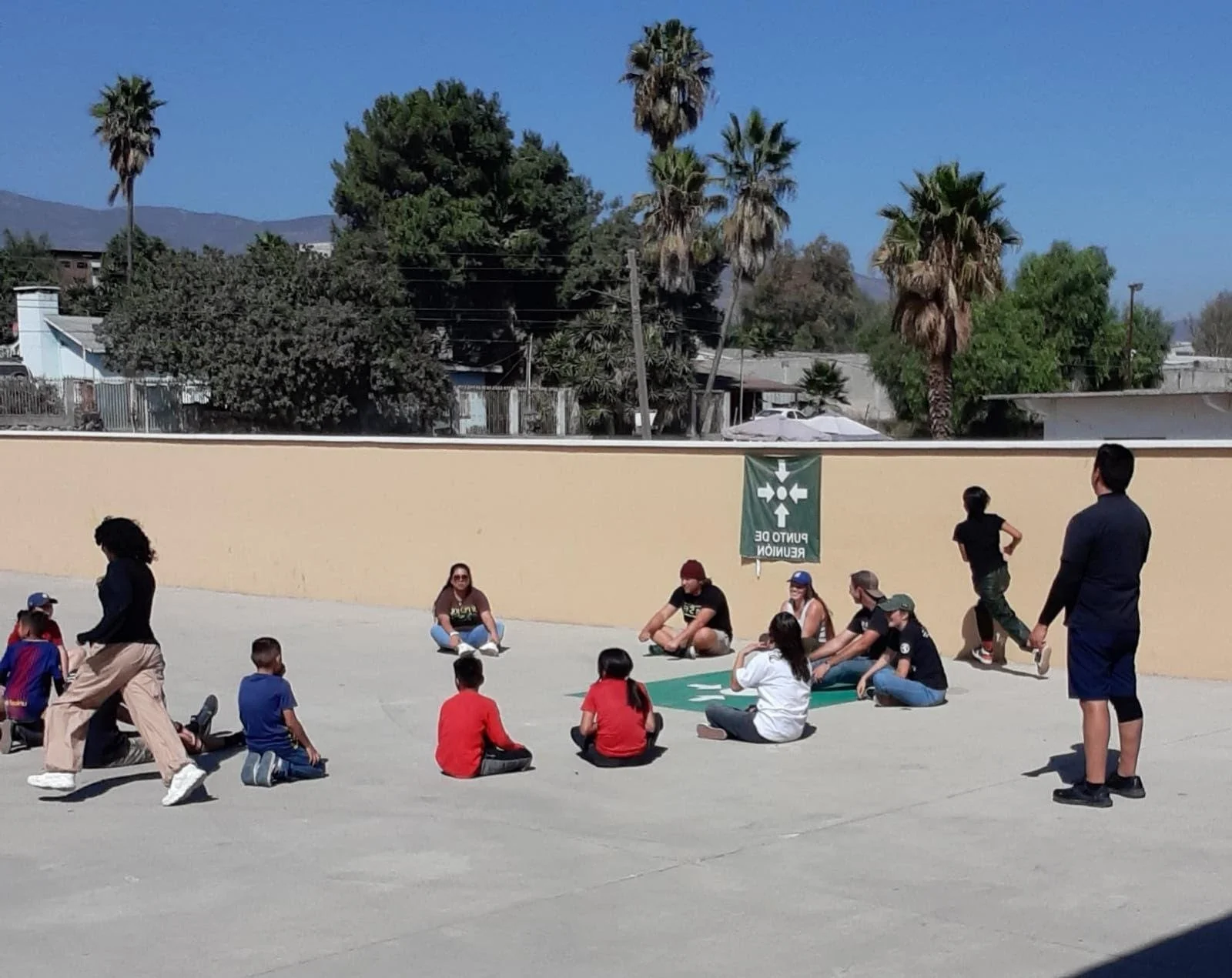 Group of kids sitting on the ground during a bible study