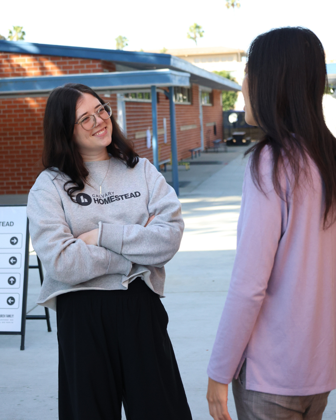 Two women talking and smiling at Calvary Homestead Buena Park.