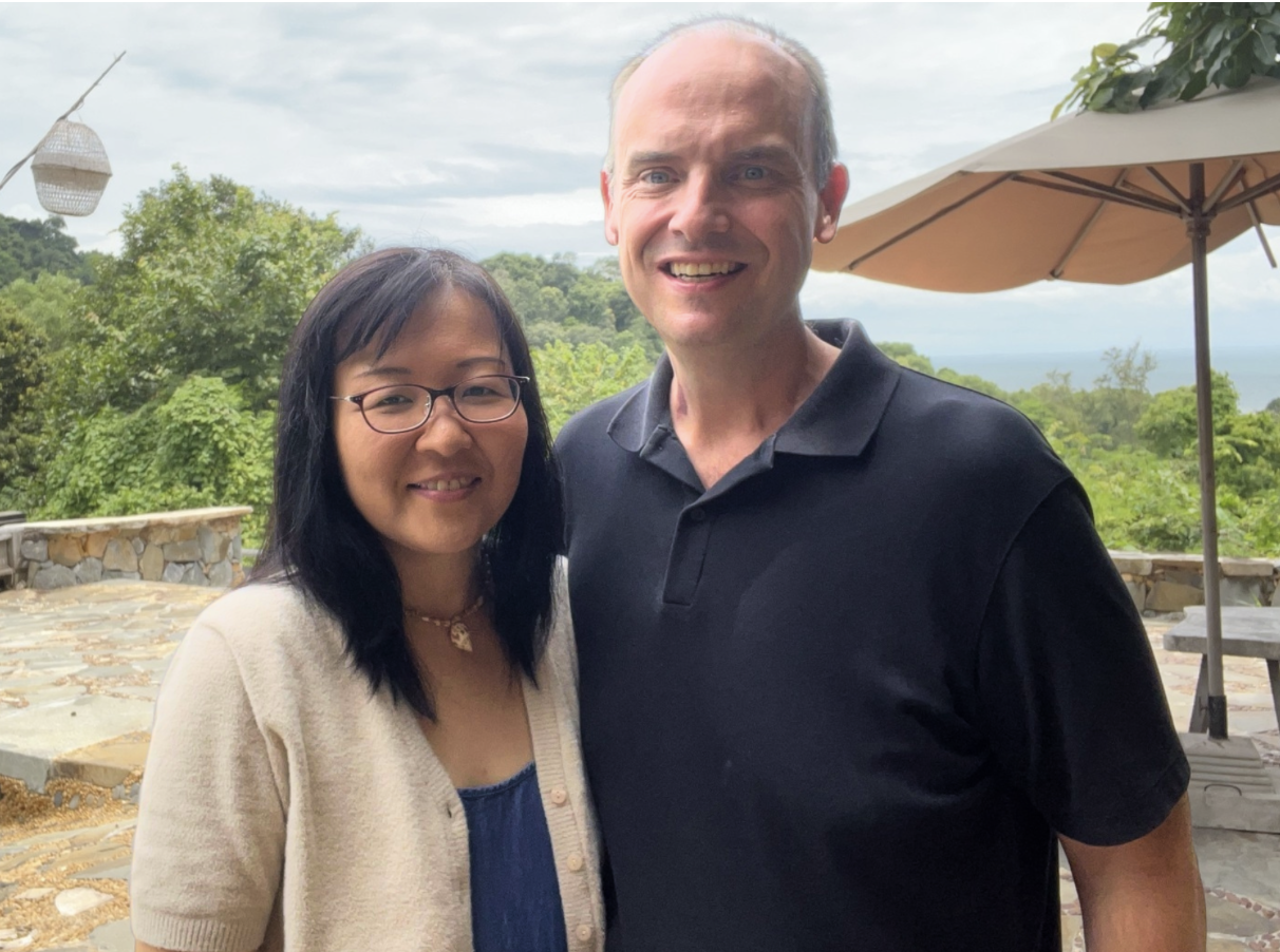 Missionary couple Darryl and Kayo standing in front of the camera smiling