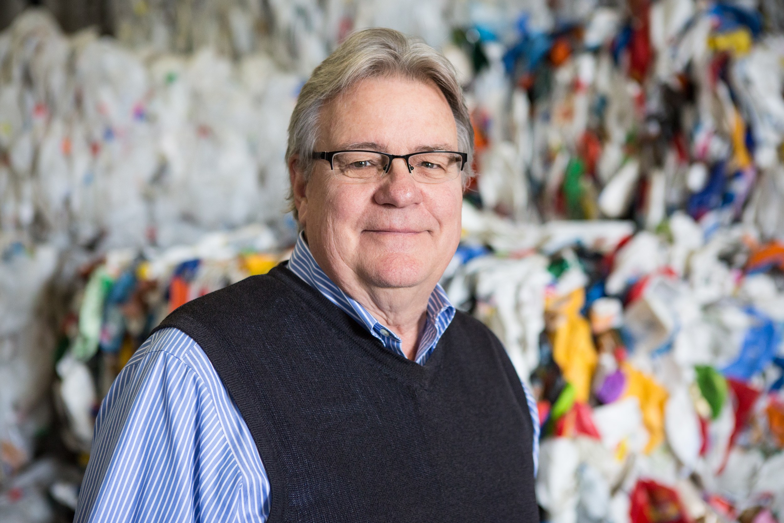 John Casella pictured with processed recyclable plastics at the Casella Zero-Sort Processing Facility in Rutland, Vermont. Photo by Ned Castle.