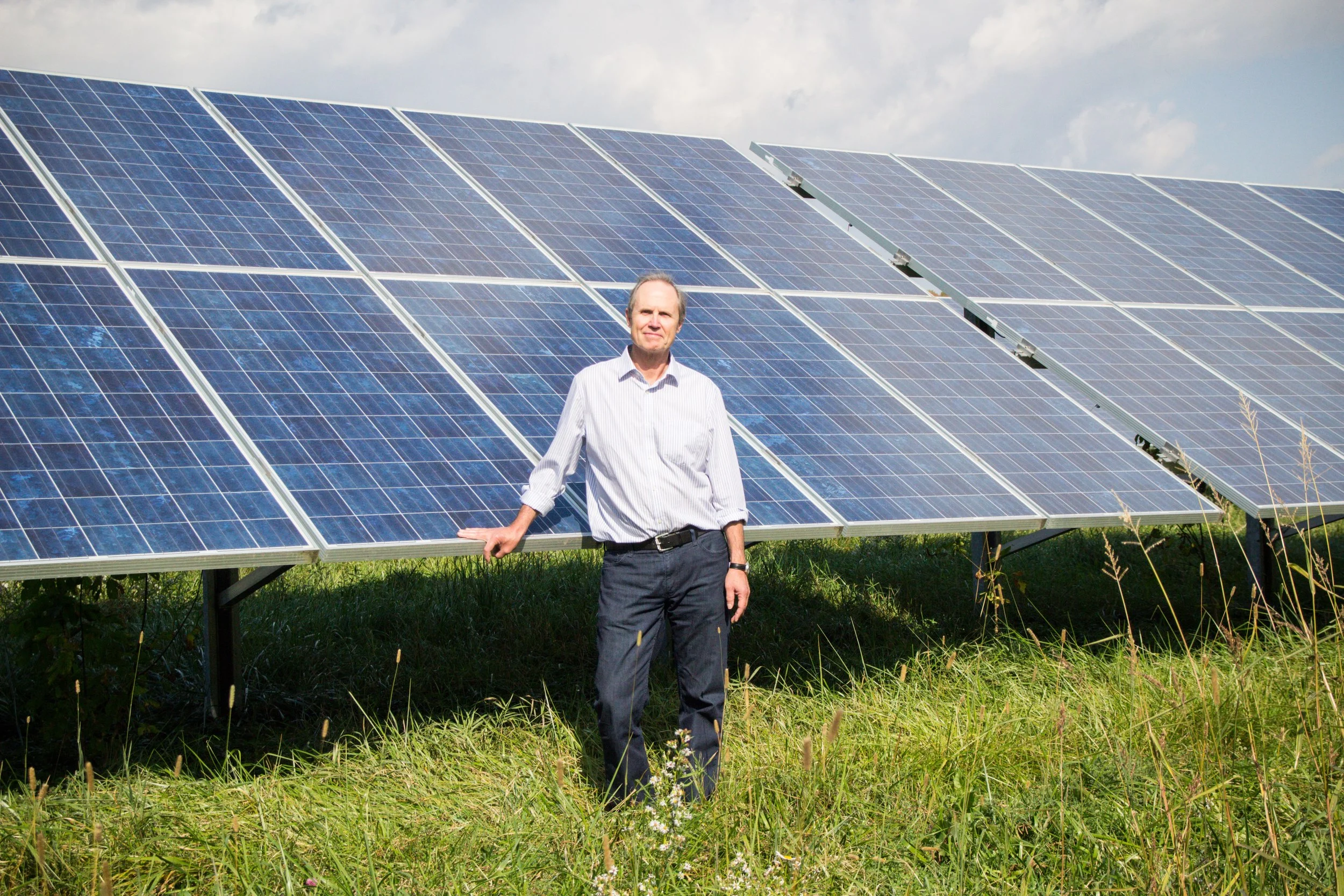 Leigh Seddon at the Ferrisburgh Solar Farm located along Route 7 outside of Vergennes, VT. The farm was built in 2010 by Alteris Renewables for the Pomerleau Real estate group and was Vermont’s first utility-scale solar installation built under Vermont’s Standard Offer Program. Photo by Dorothy Weicker.