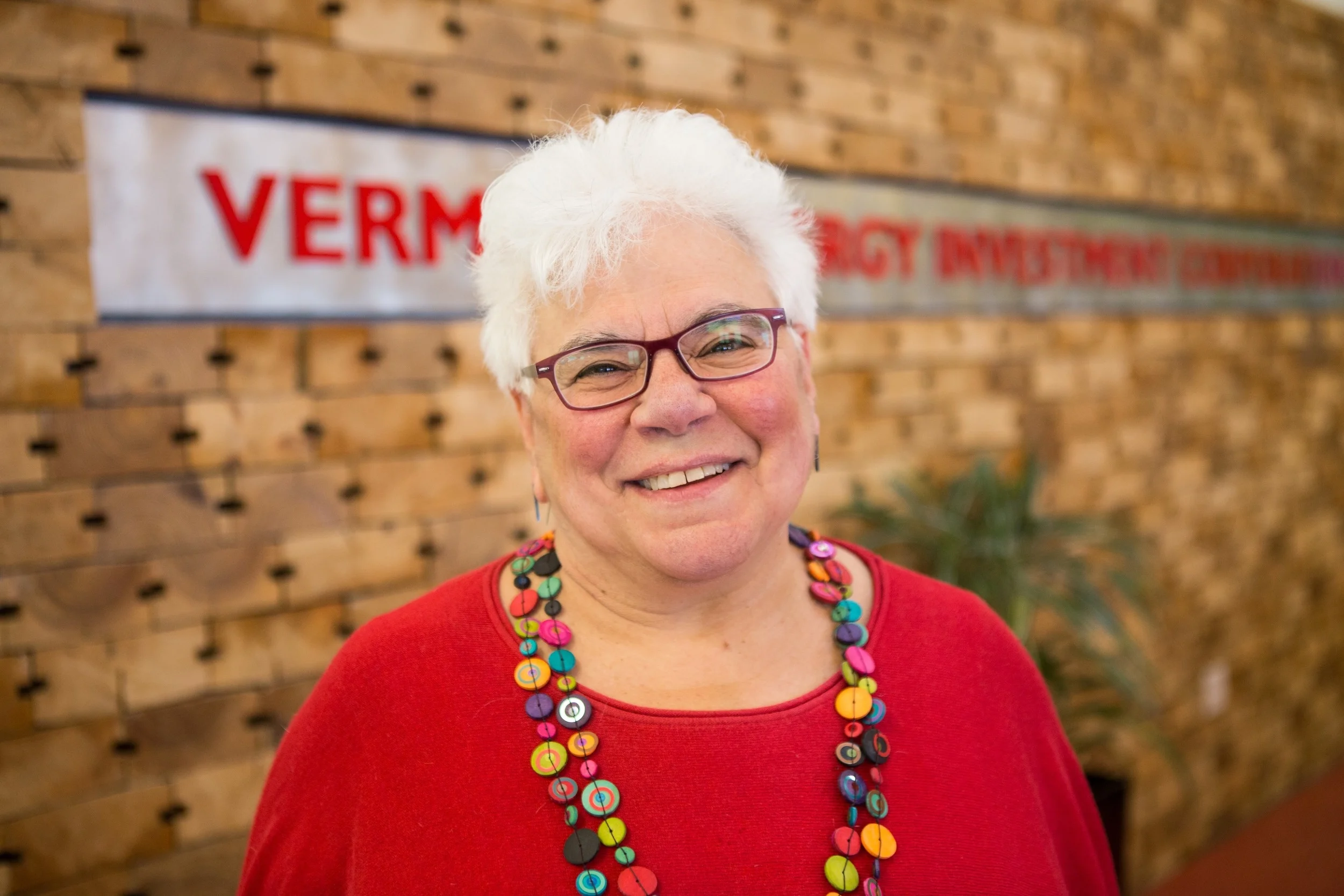 Beth Sachs at the entrance of the Vermont Energy Investment Corporation headquarters at the Innovation Center in Burlington, VT. Photo by Ned Castle.