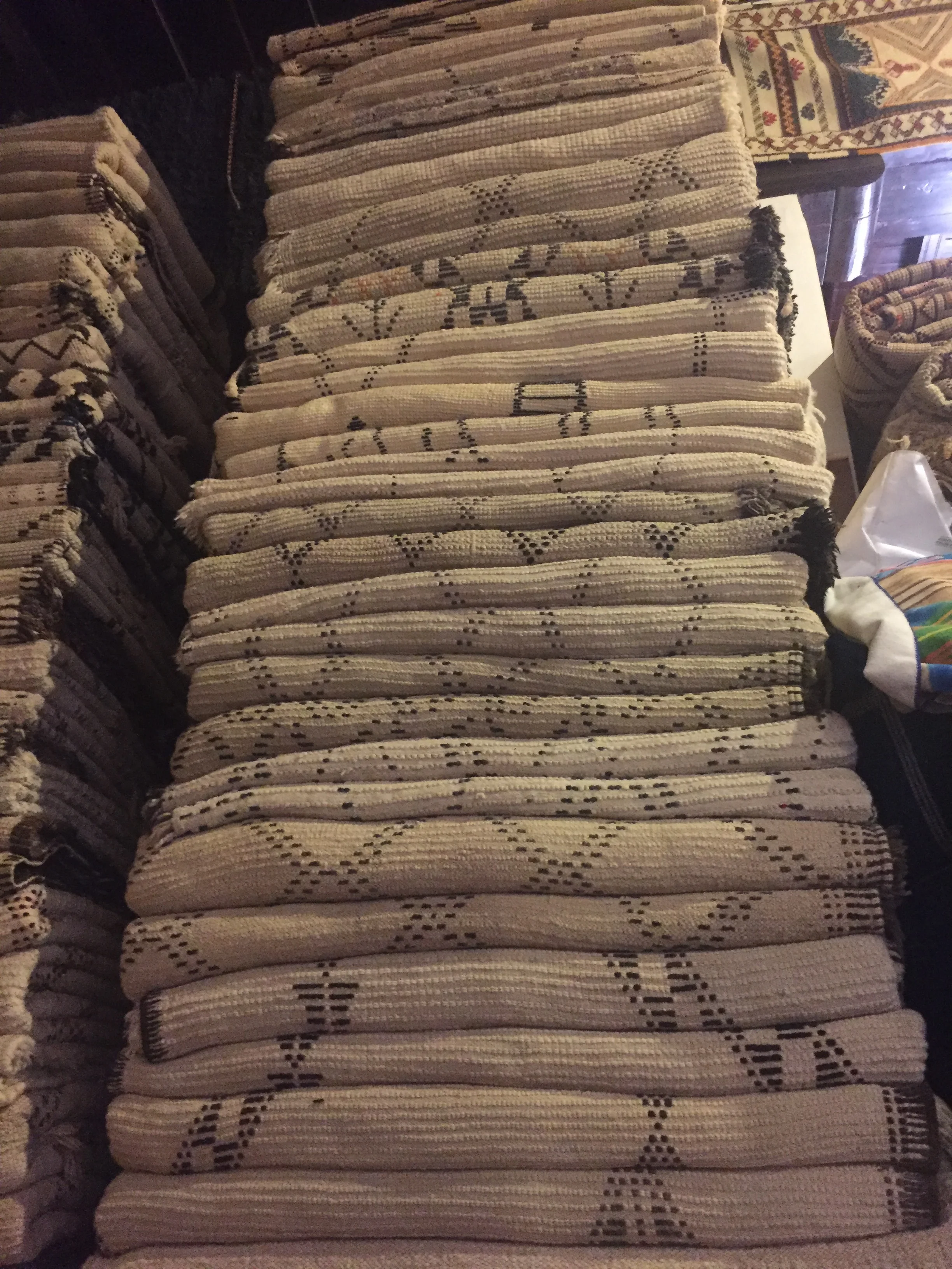 Big stack of Beni Ourain Berber rugs, some headed to Toronto, Canada.