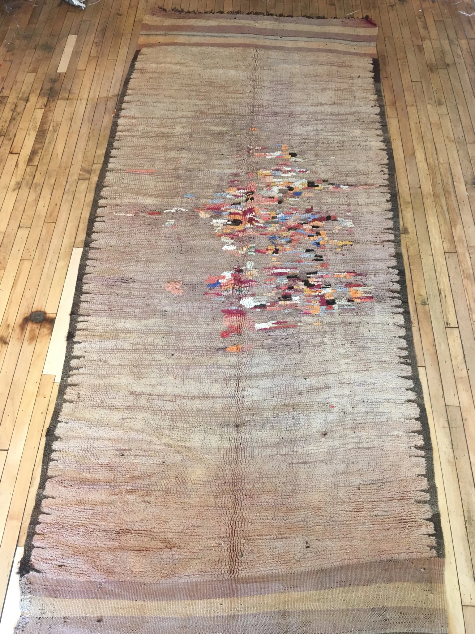 This is an antique, monochromatic Rehamna that has been repaired. It is an incredible, one-of-a-kind piece available at Mellah, our rug store in Toronto.