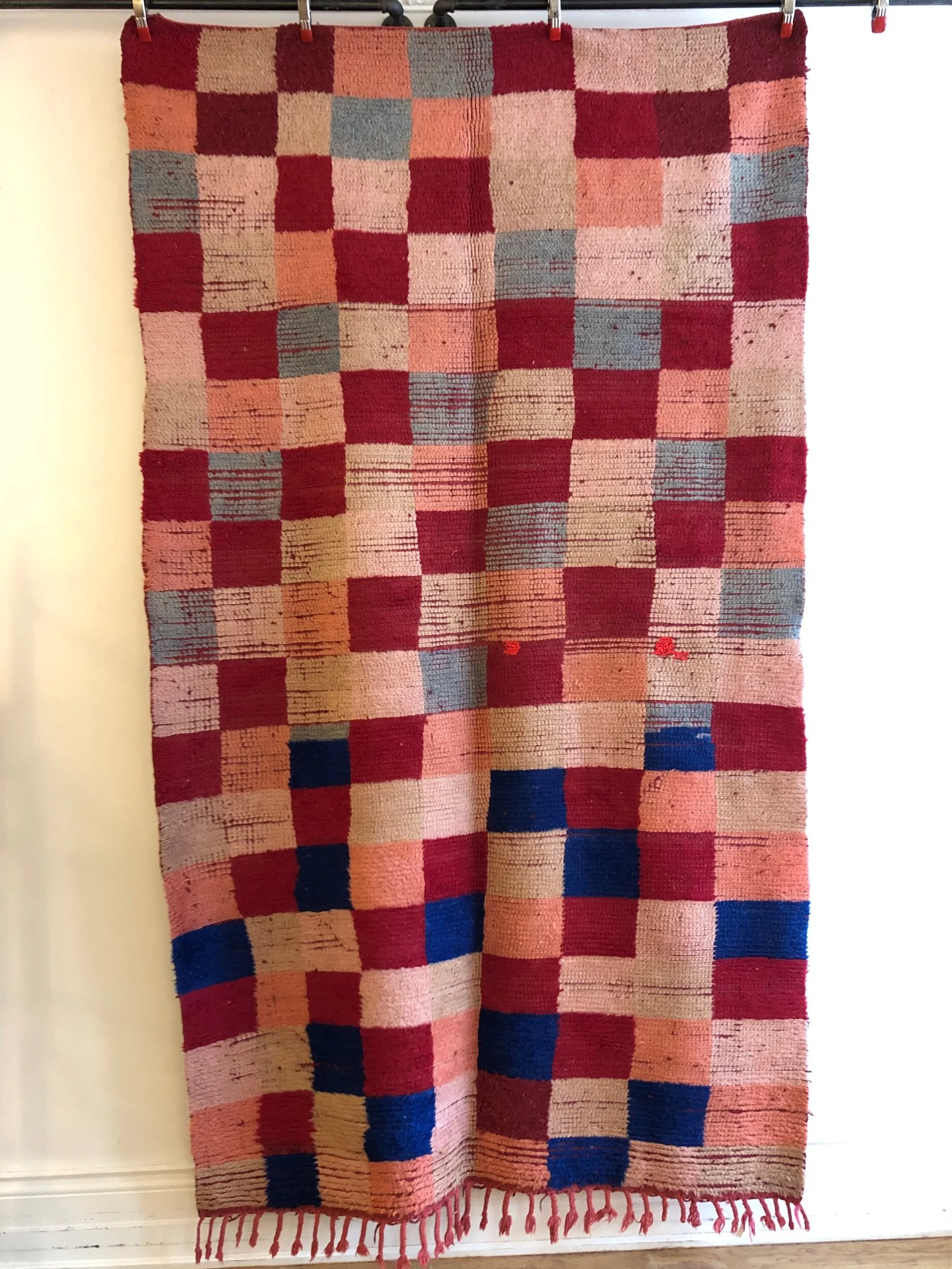 vintage moroccan wool rug with red, pink, sky blue and bright blue checkerboard pattern