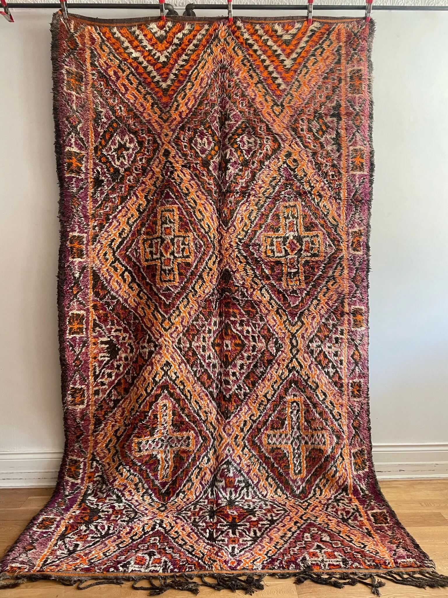 oversized burgundy beni Mguild Moroccan wool rug with large orange diamonds