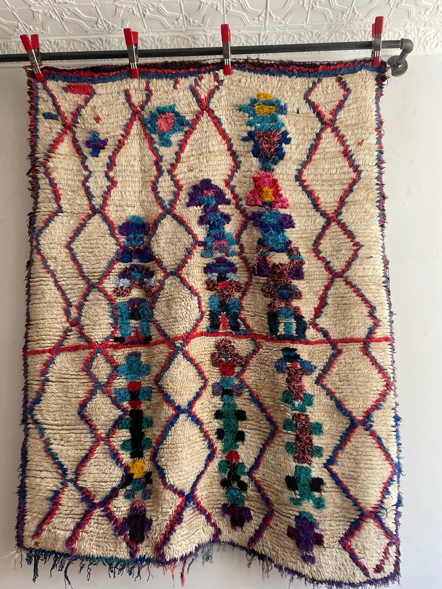 vintage Moroccan wool rug with cream base and blue and red diamonds with colorful flowers
