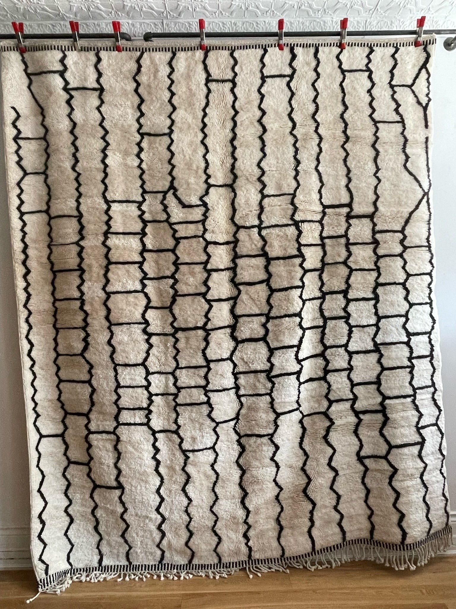 Modern cream Moroccan wool rug with black zig zag grid