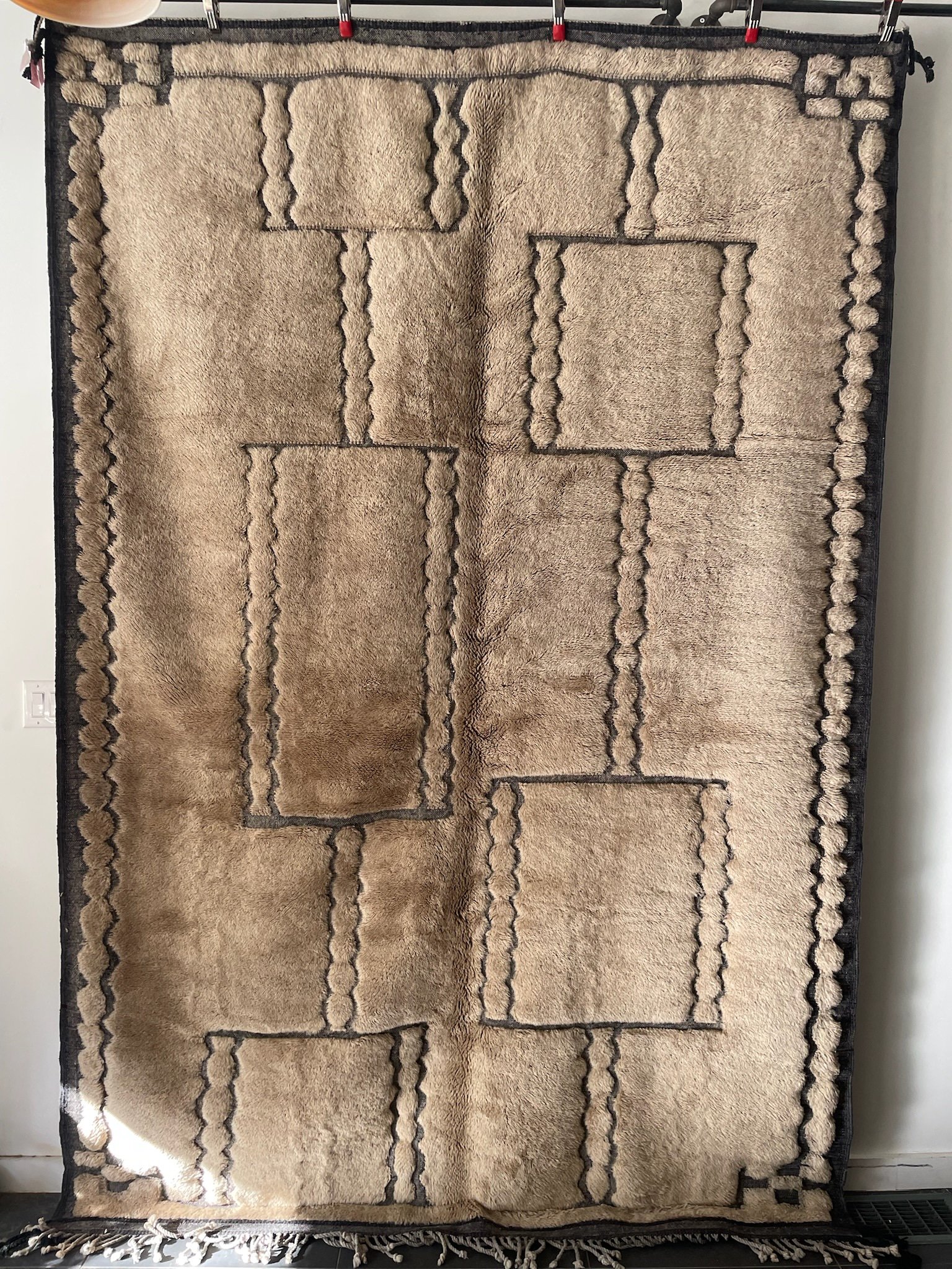 Soft brown hand-knotted Moroccan wool rug with chic minimal black designs and border