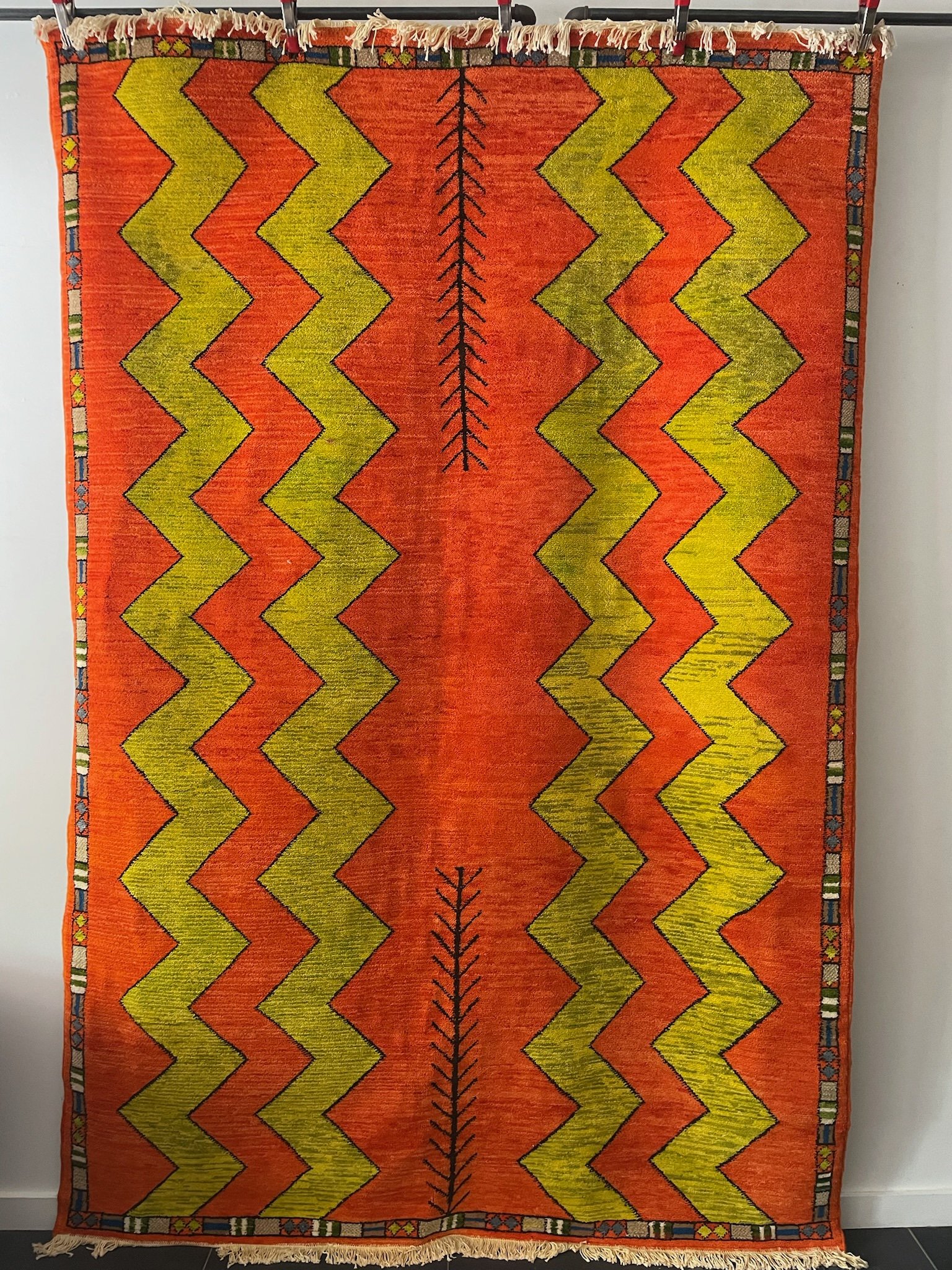 low-pile, hand-knotted, brat green and orange Moroccan wool rug with wide zig-zag pattern and chocolate brown details