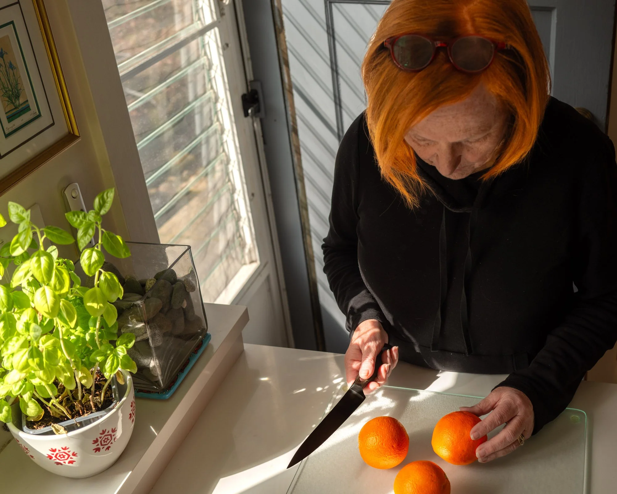 Neighbor cutting an orange 