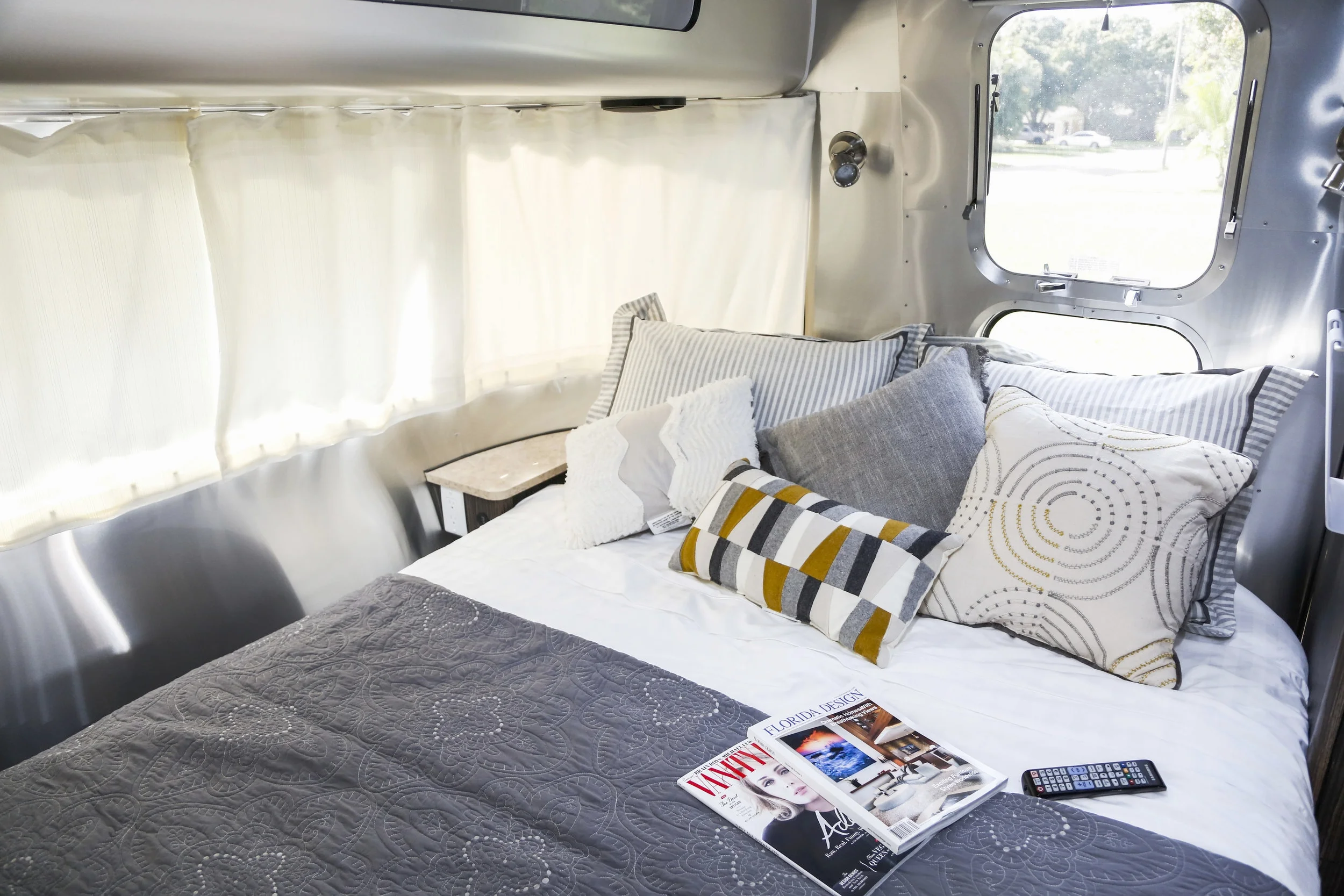 The bedroom features a premium queen bed and lots of natural light, but privacy curtains when you need them.