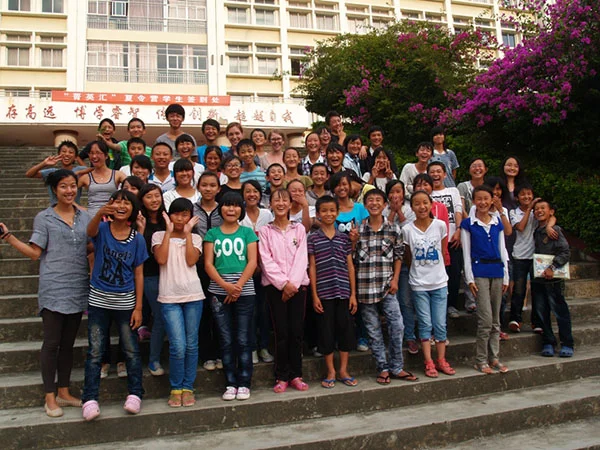 Students pose for a photo outside their classroom.