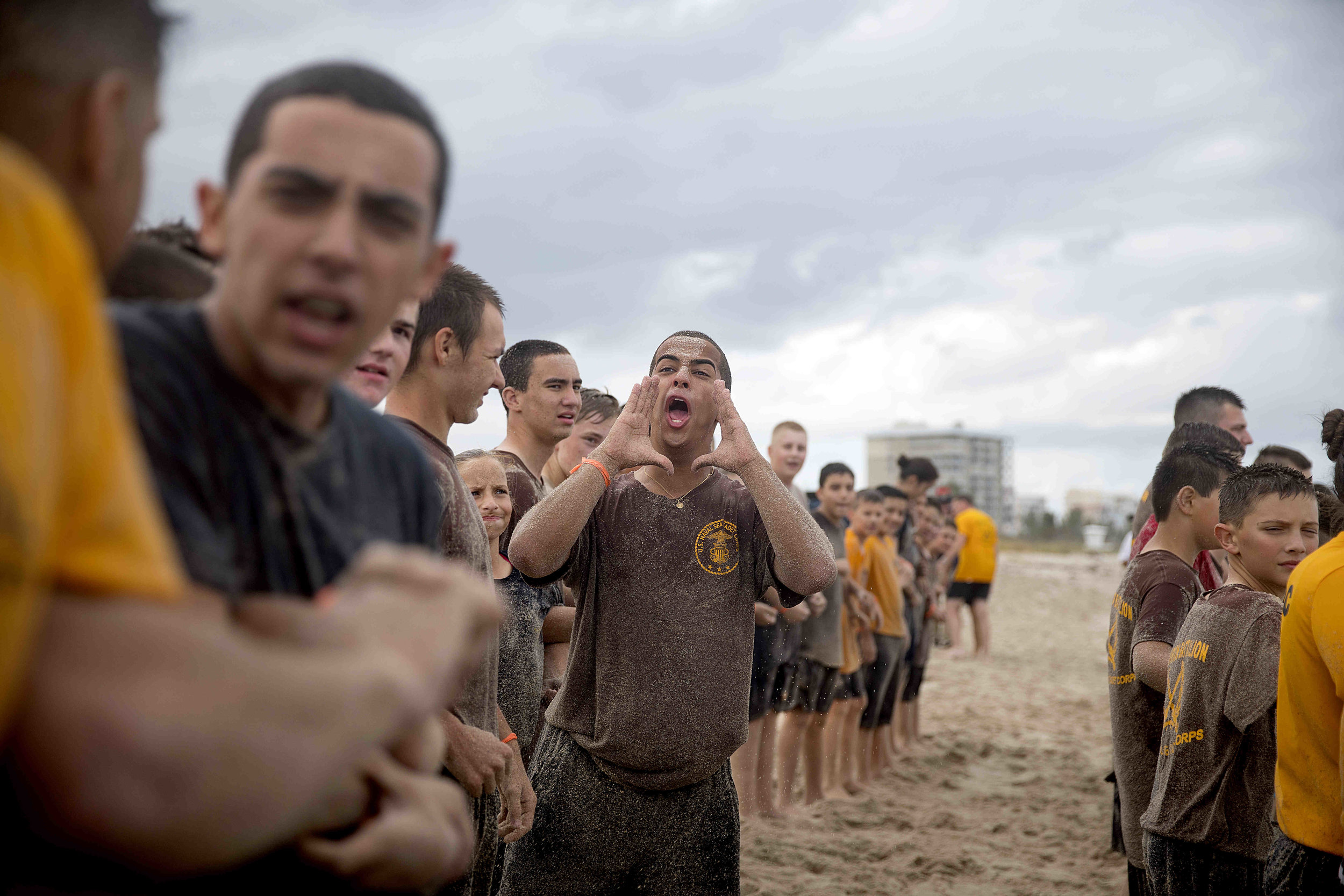  U.S. Naval Sea Cadet Corps Seaman Apprentice Cadiz, Centurion Battalion, provides a rallying cry to his shipmates during beach physical training. Cadets perform a variety of types of community service benefiting their hometowns, by participating in 