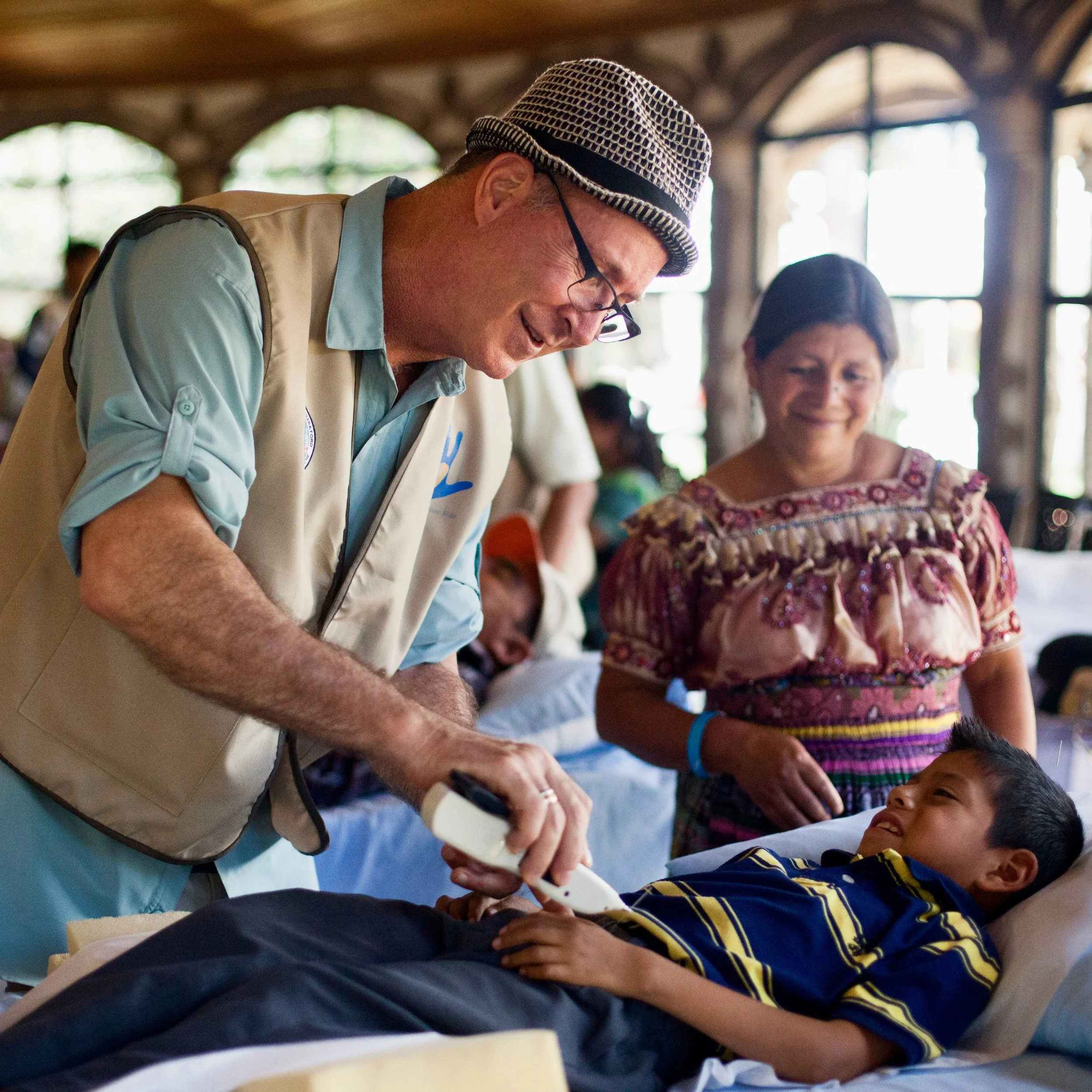 GHF Website Home-06 Dan with Brian smiling with estim pointer and mom copy.jpeg