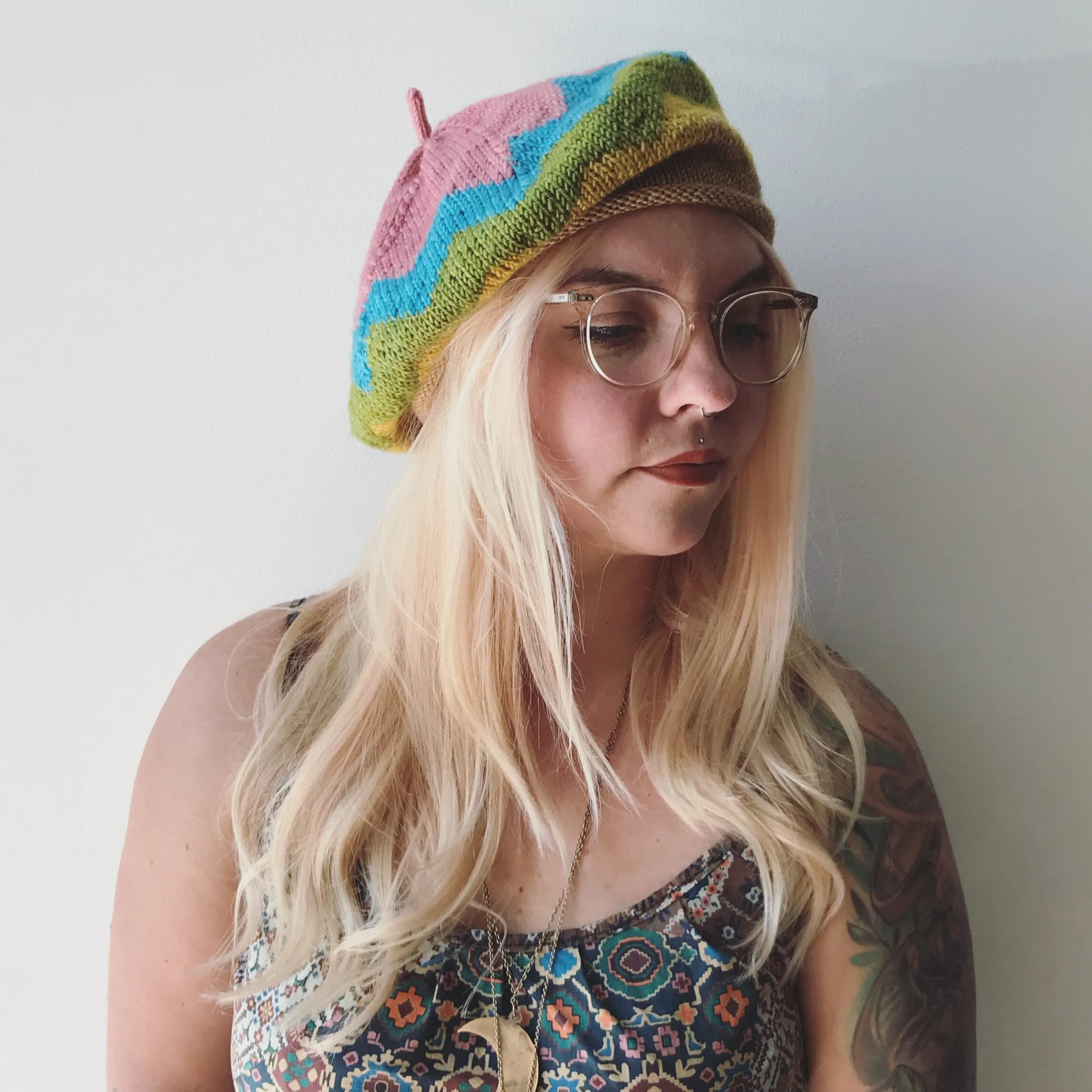 Tina wearing knitted beret with colorful chevrons