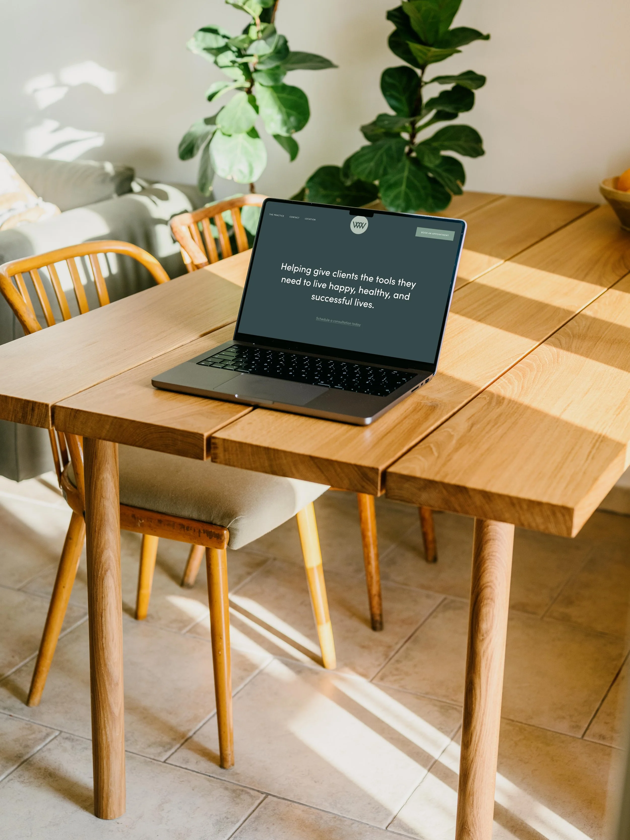 mockuuups-macbook-pro-mockup-on-a-table-with-a-plant-in-the-background.jpeg