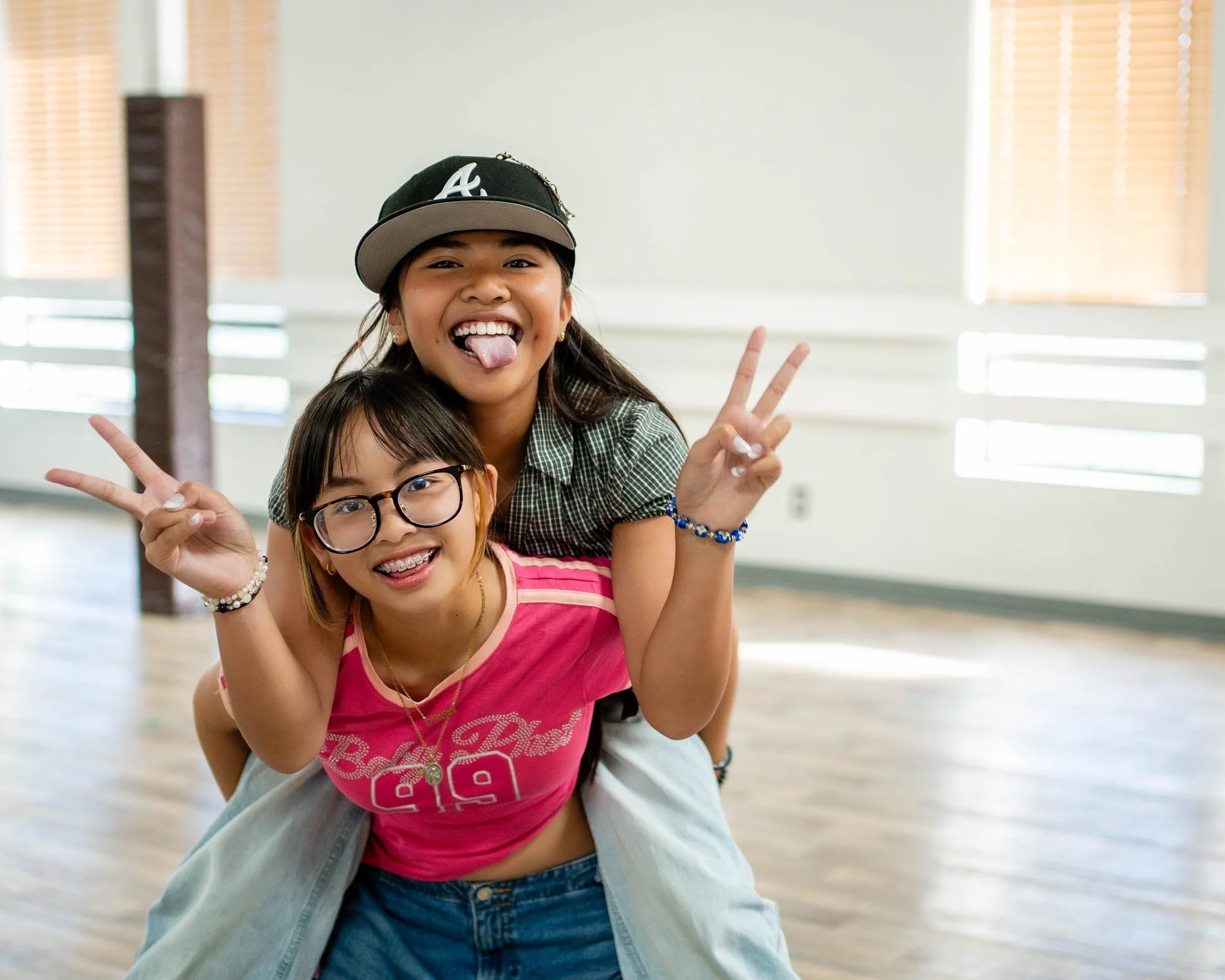 Students smiling during a hip hop dance class at re.DEFINE Dance Studio in Hayward, California.