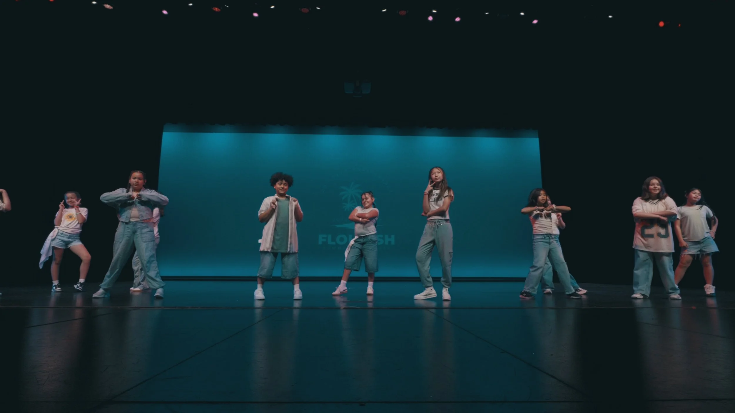 Beginner Kids Hip Hop dancers performing on stage at a re.DEFINE Dance Studio showcase.