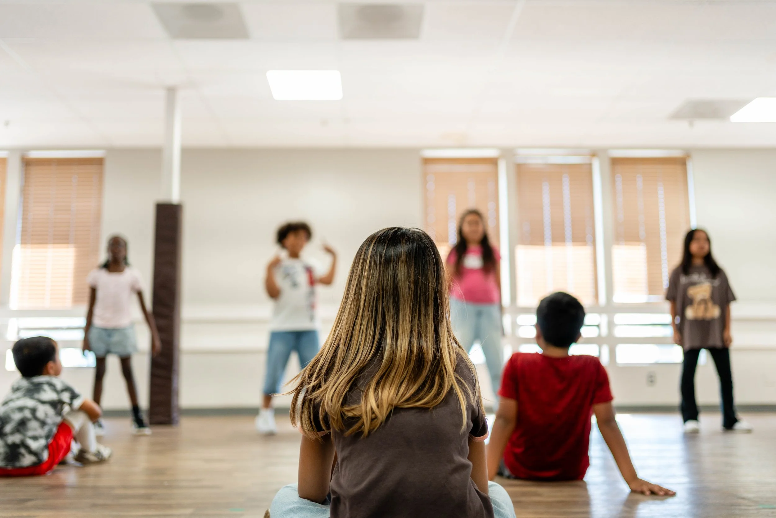 A student watches her fellow dancers perform during a hip hop dance class at re.DEFINE Dance Studio in Hayward, California.