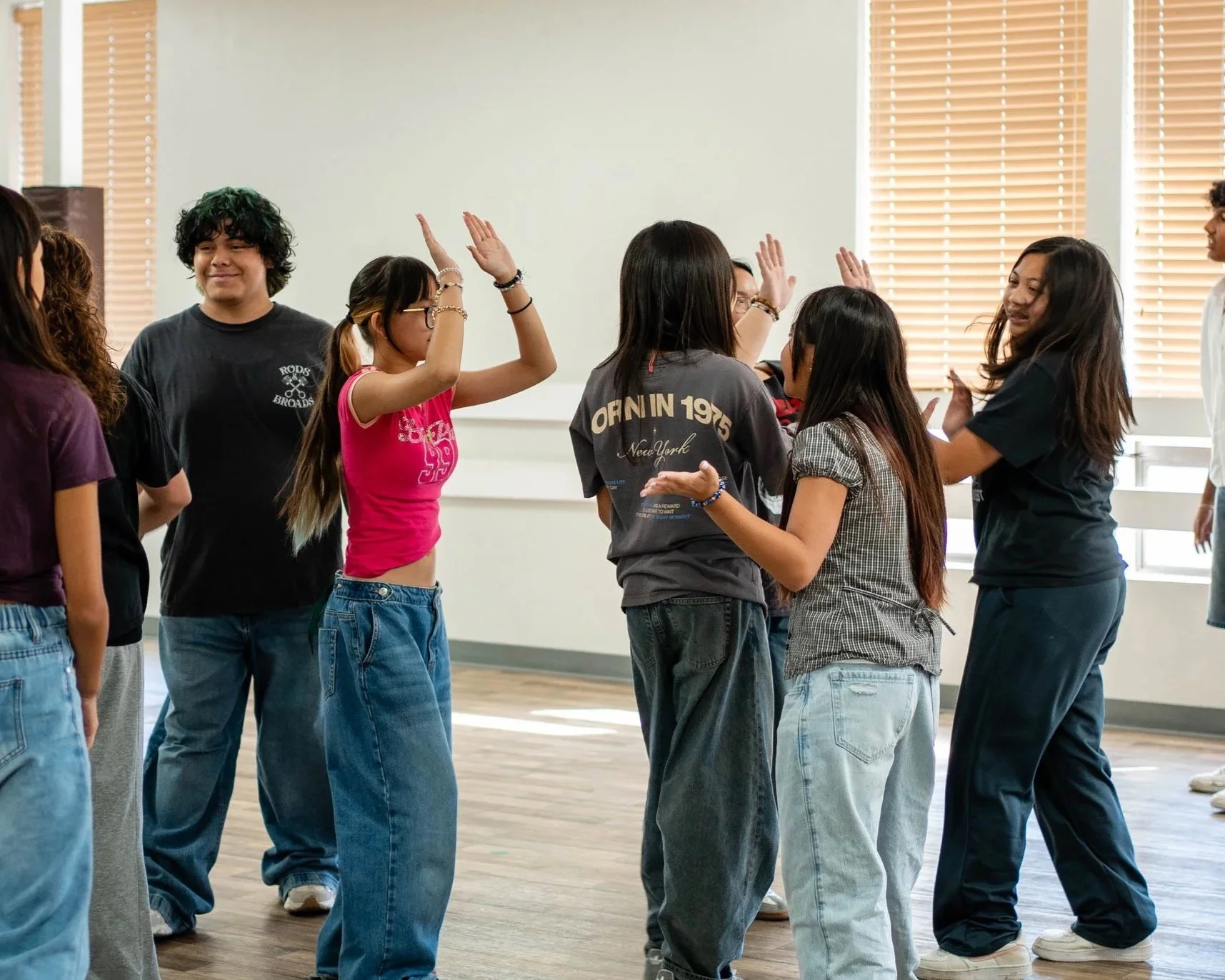 Students connecting and encouraging one another during a hip hop dance class at re.DEFINE Dance Studio.