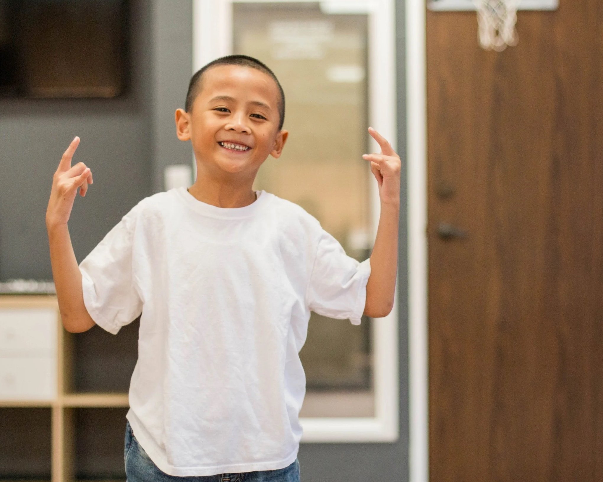 Jacob, one of the first students at re.DEFINE Dance Studio, smiling inside the Hayward dance studio.