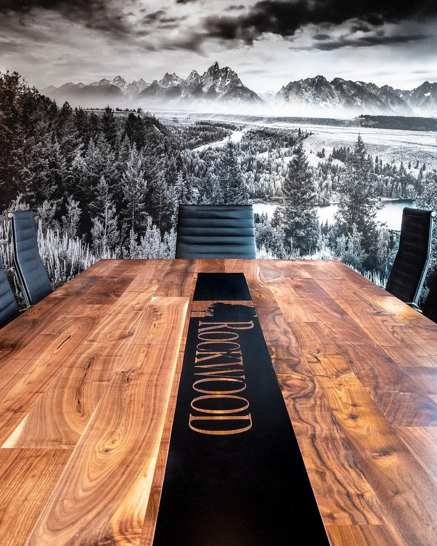 Conference Room pic! @revamptgoods designed and fabricated this sweet custom conference table for us, wall by @muralsyourway #eameschairs pic by @brettfoxstudio 🖤
