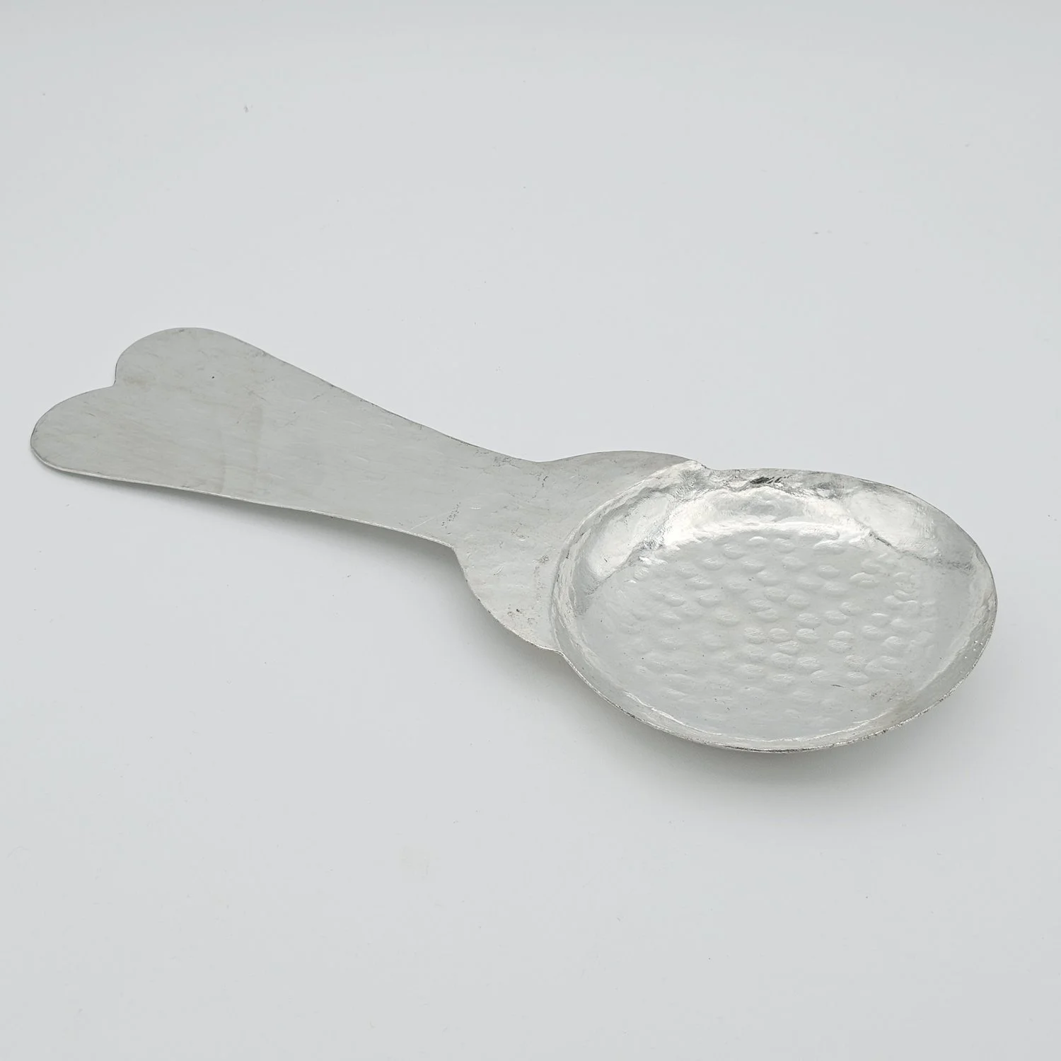 handmade Spoon rest copper with a hammered bowl, on a white background.