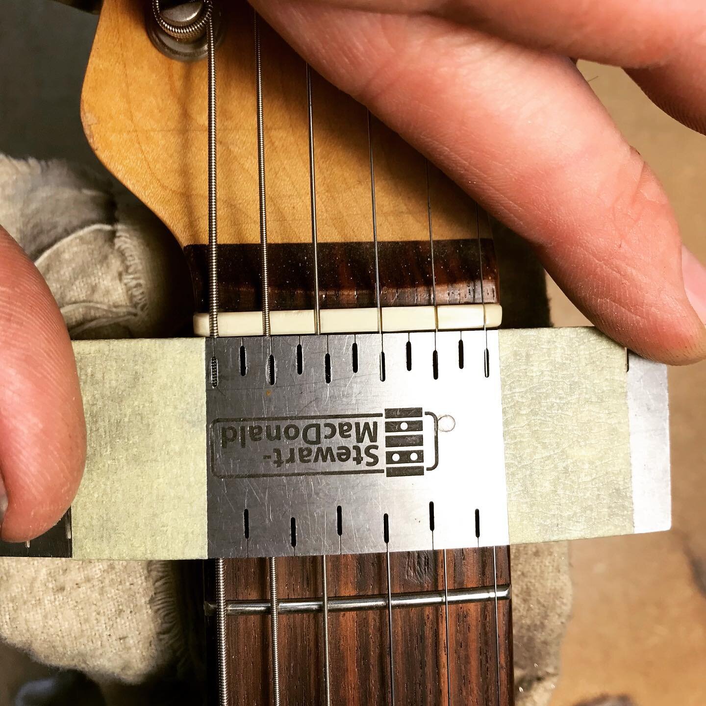 A before, during and after of the nut I made for a Telecaster. The string spacing was pretty far off, most noticeably on the fourth and fifth strings and so I wanted to make a new one. 

This string spacing ruler is so helpful. Marked some new lines,