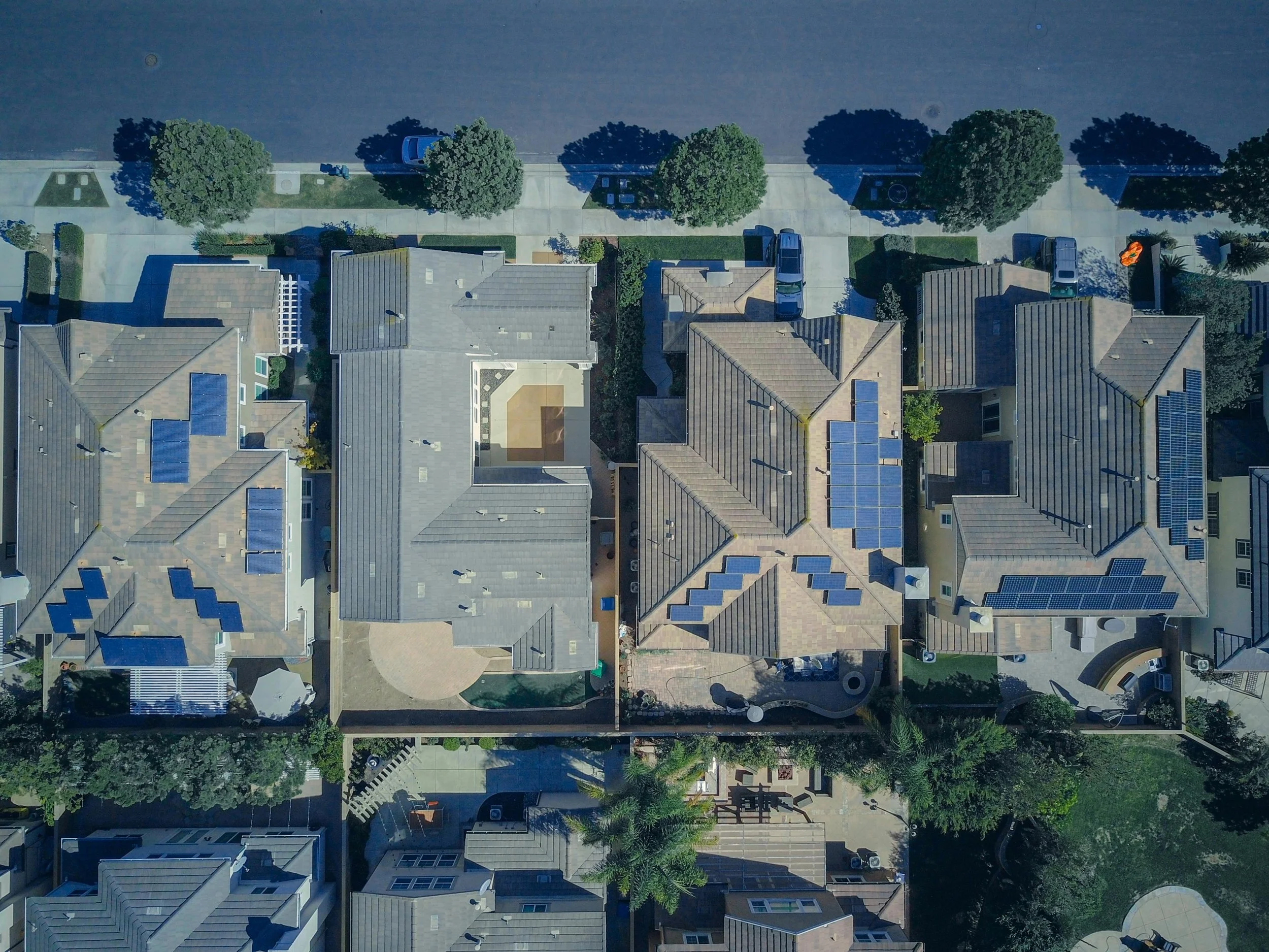 Aerial view of residential homes with rooftop solar panels