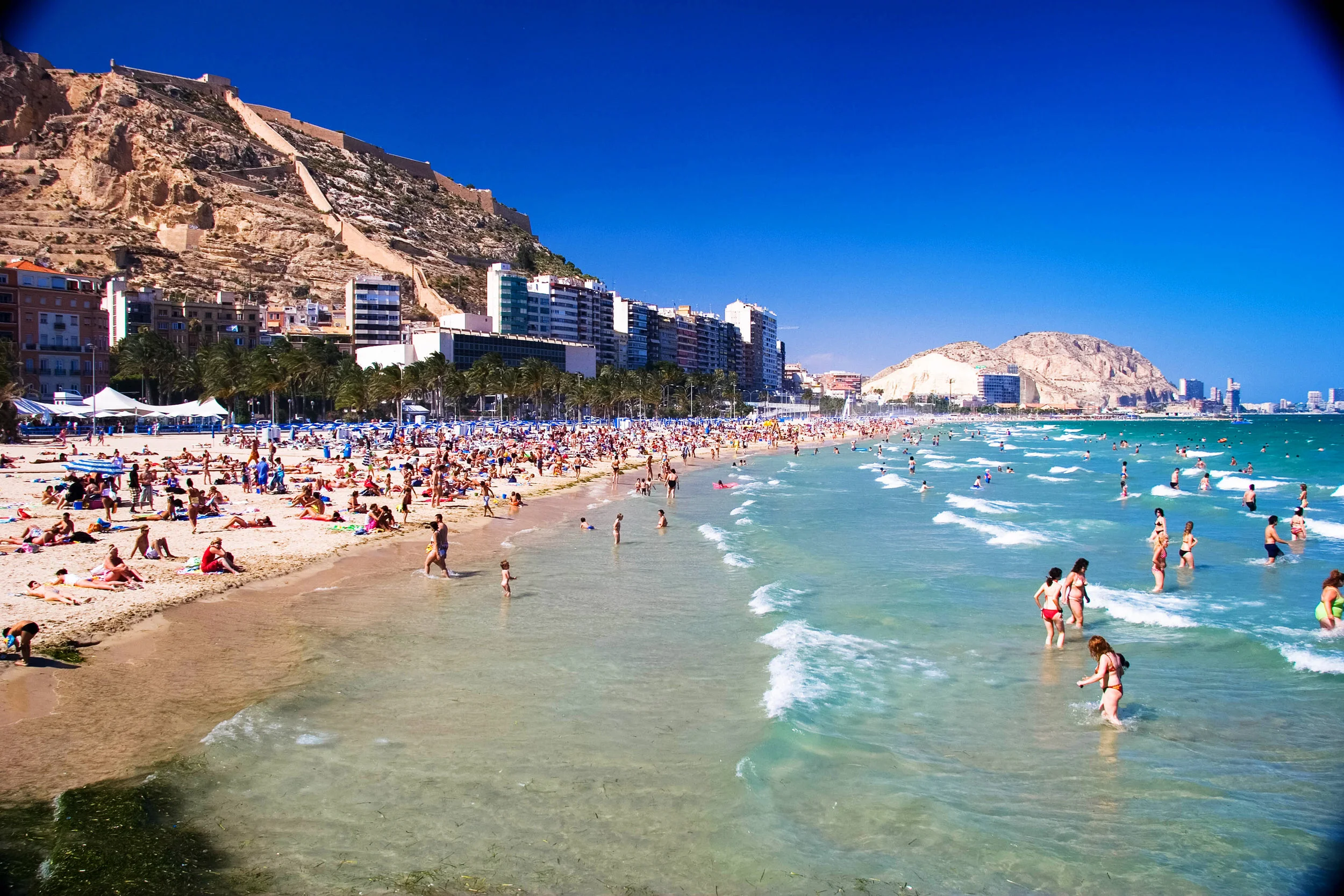 Mid day swim on the public beach. Alicante, Spain