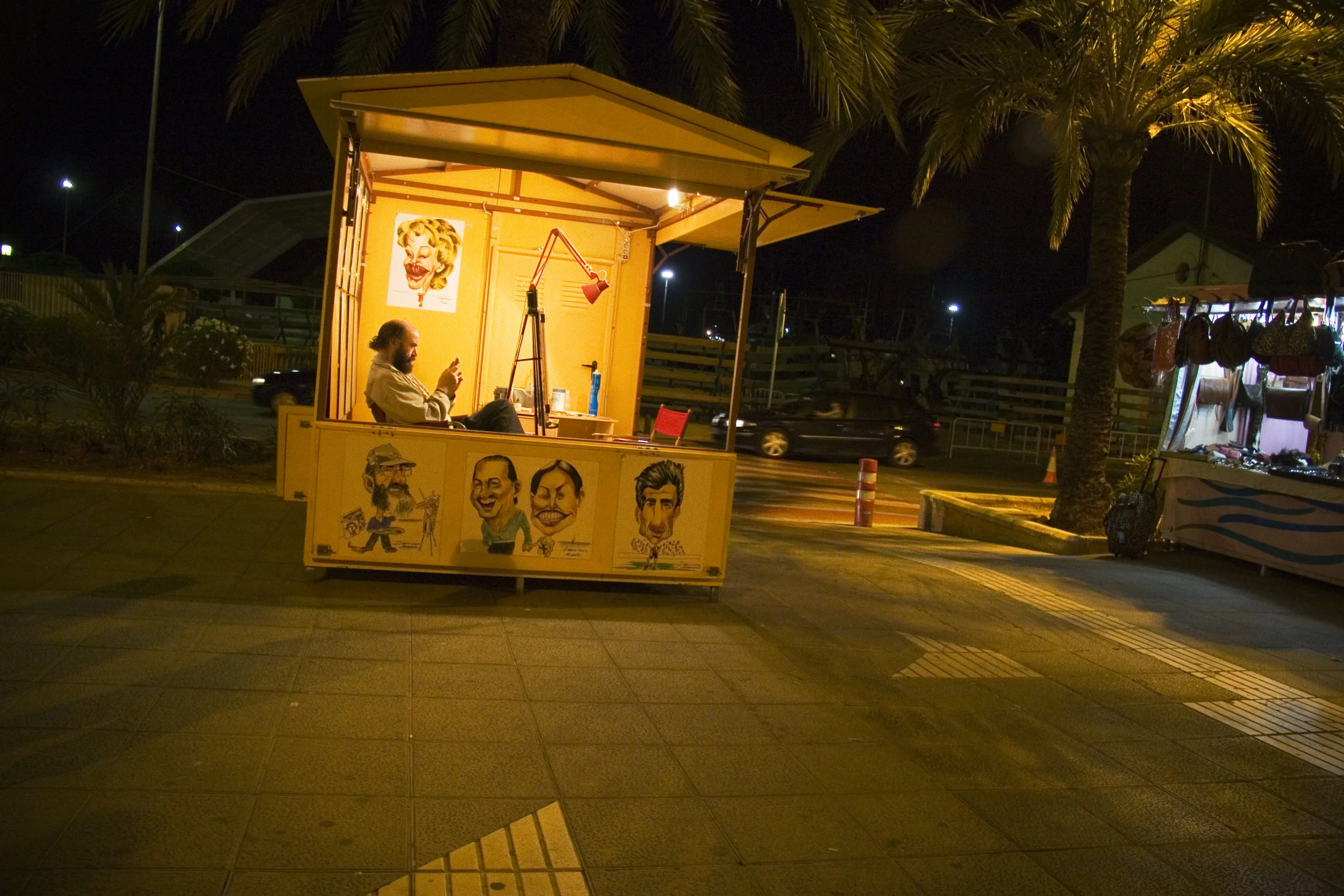 Caricature artist on the boardwalk. Denia, Spain