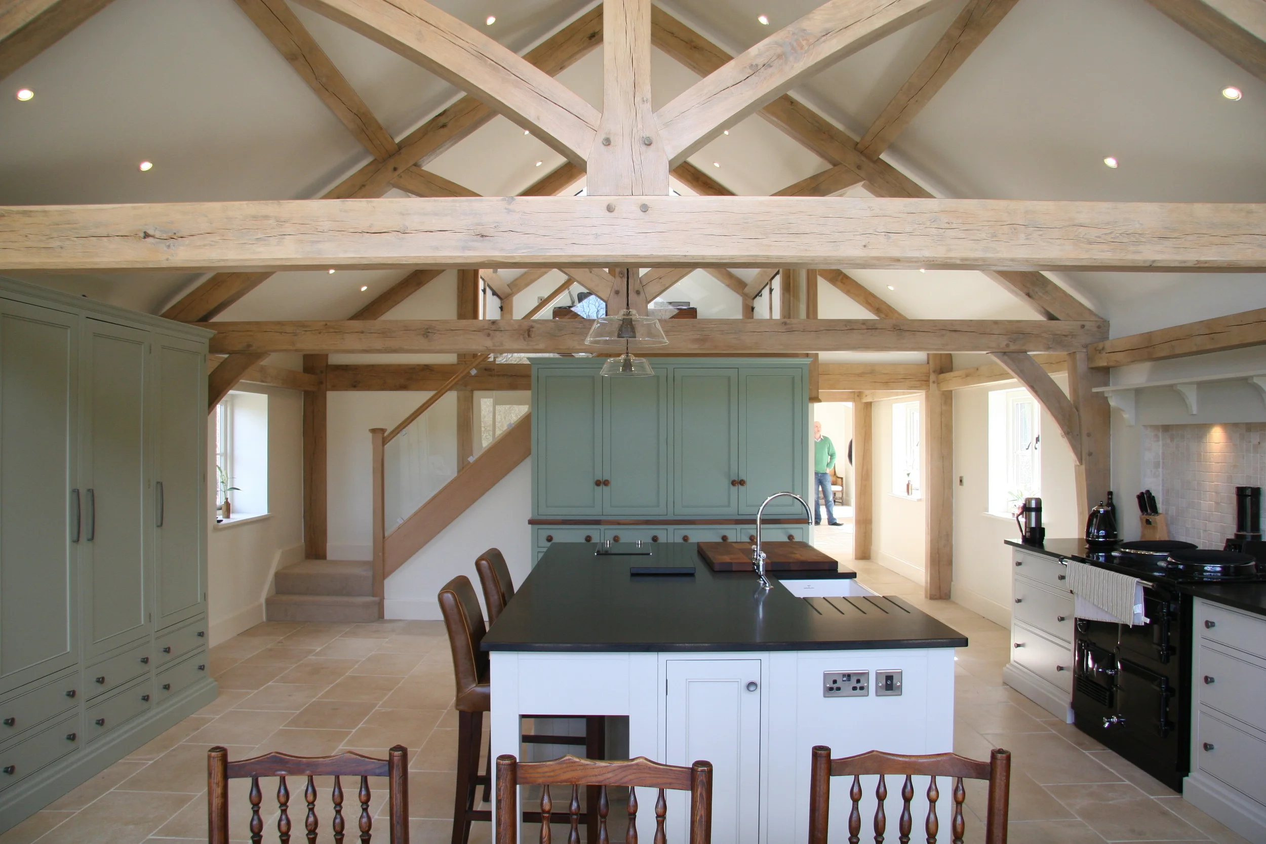  Traditional exposed oak framing and roof trusses combined with contemporary materials create a cohesive look that enhances the space as a whole. 