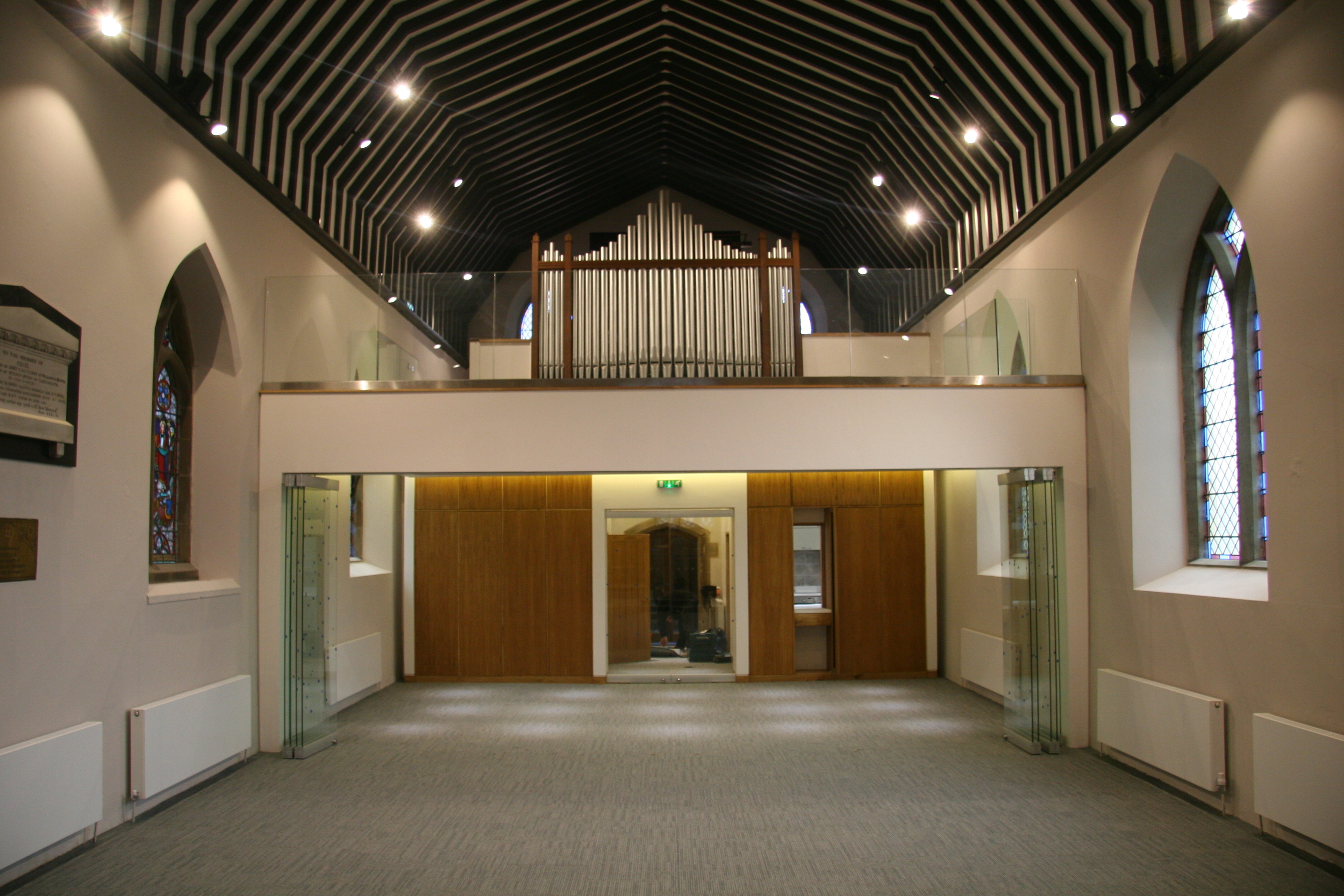  The glazed screens can be folded back and the chairs stored away to create a flexible, multi-purpose function space.  The kitchen servery hatch can be concealed behind the oak panelled 'storage wall'. 
