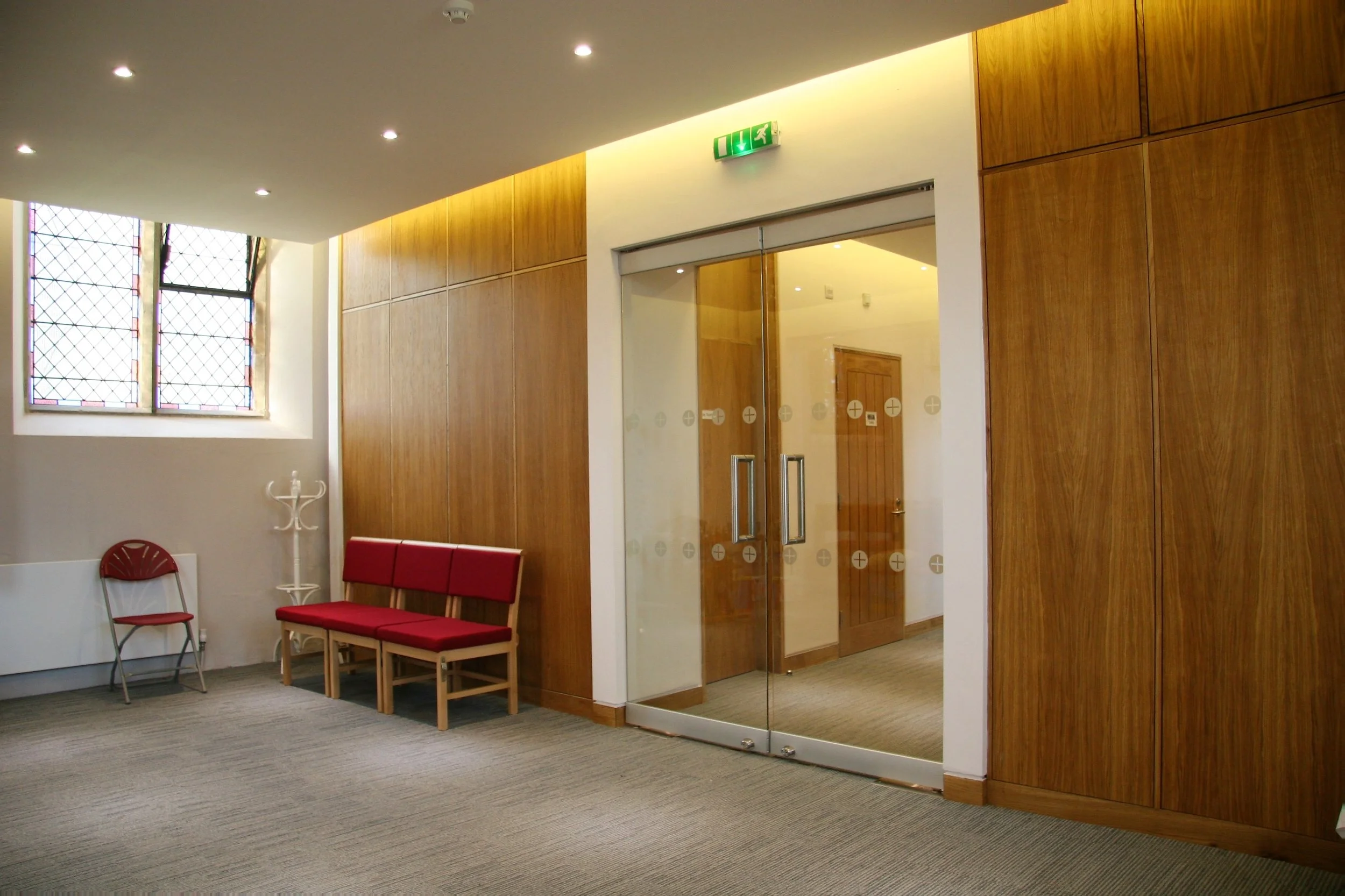  The new Function Space accommodates full height storage cupboards and a servery hatch; all concealed behind the oak panelling.  A new floating ceiling with task and periphery mood lighting allows for an additional mezzanine floor above. 