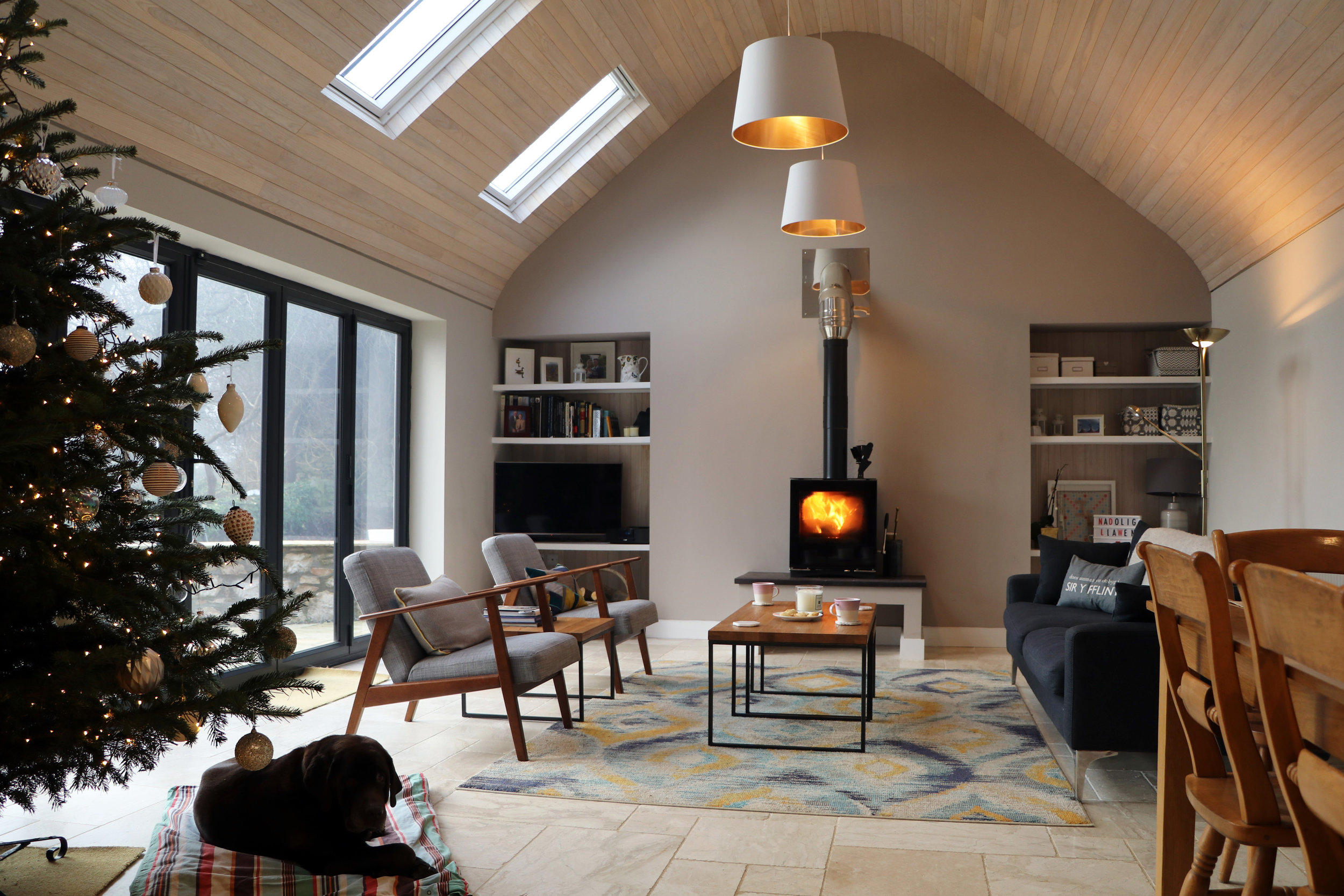 Built-in shelving together with a multi-fuel burner and a subtly painted feature gable forms a welcoming focal point to the space.