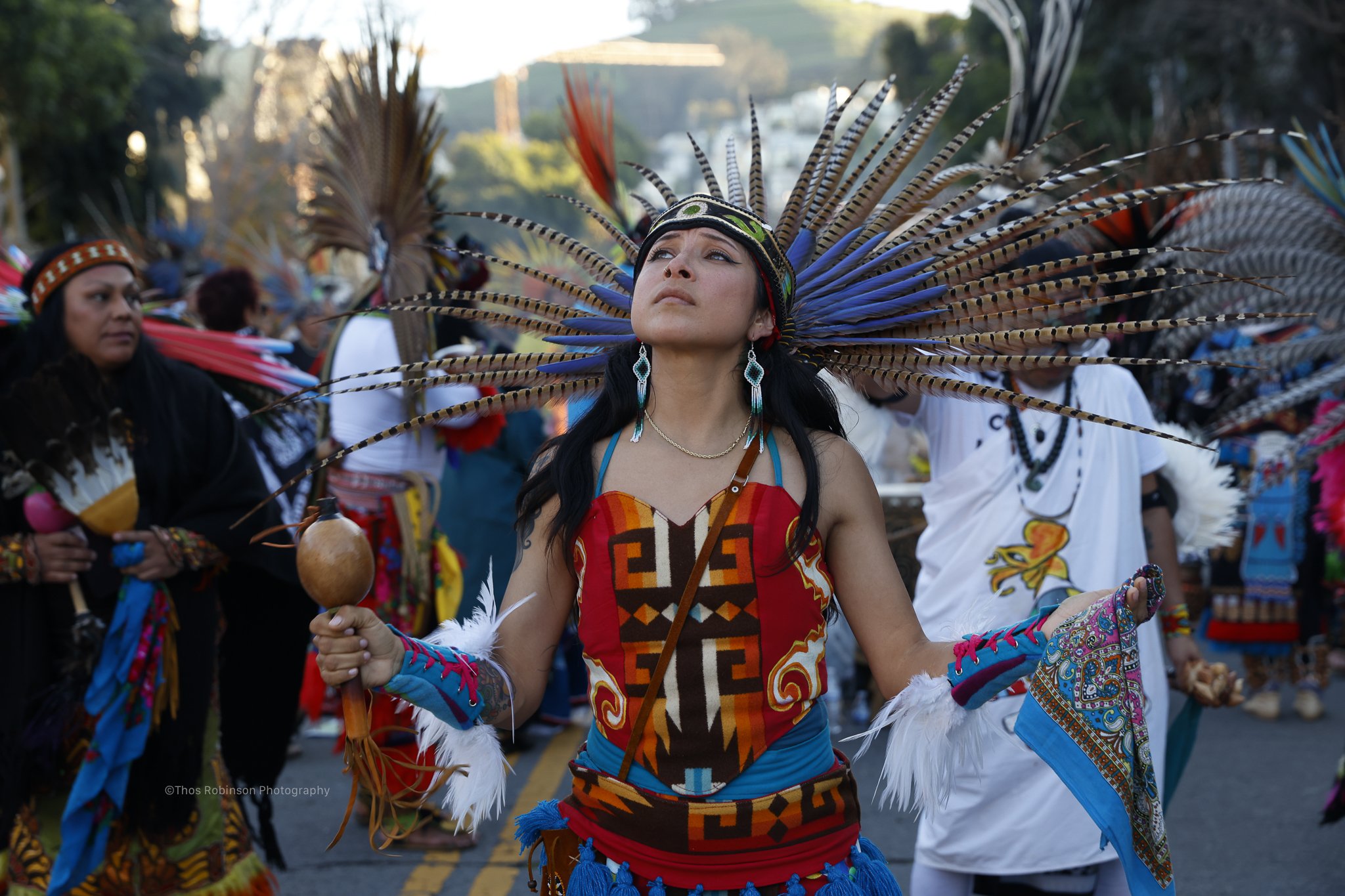  Dancer partakes in traditional Aztec homage to a lost member of the Mission District community in San Francisco, CA 