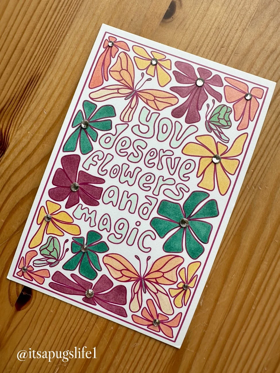 Colorful handmade card with butterflies and flowers, with an embossed message: "You deserve all the love, flowers and magic". Rhinestones adorn the butterflies.