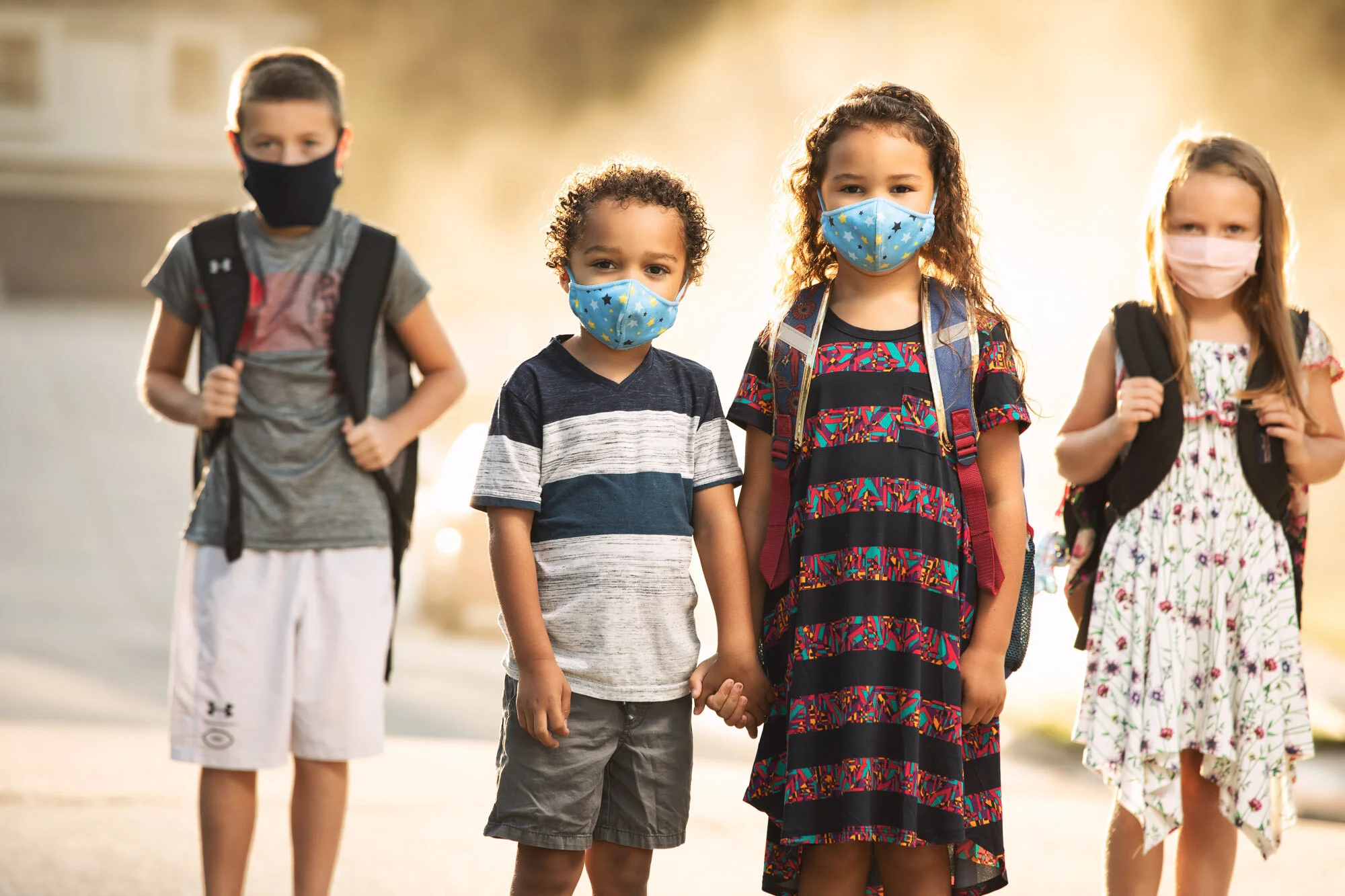 Students and kids in neighborhood pose before school with a mask on, for the Together We Can Campaign for the Council Bluffs Community School District.