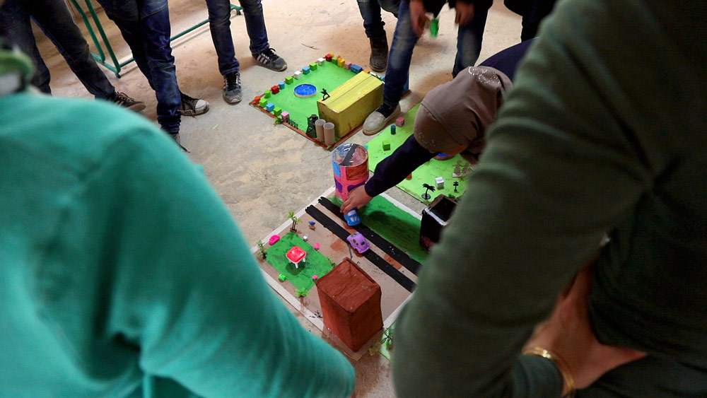 The children taking turns choosing a memento from the sessions.
